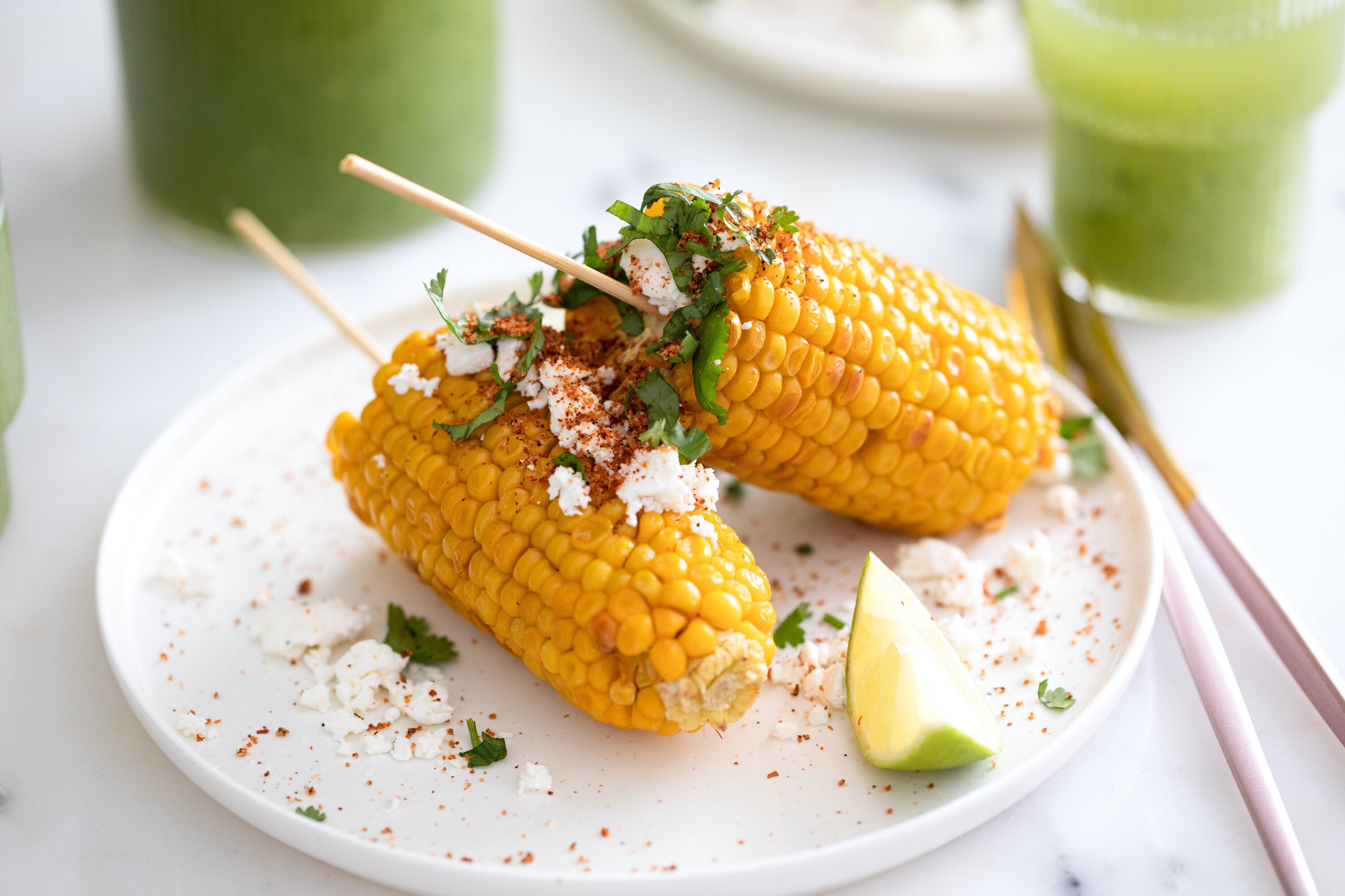 Mexican elote on a plate with kesong puti
