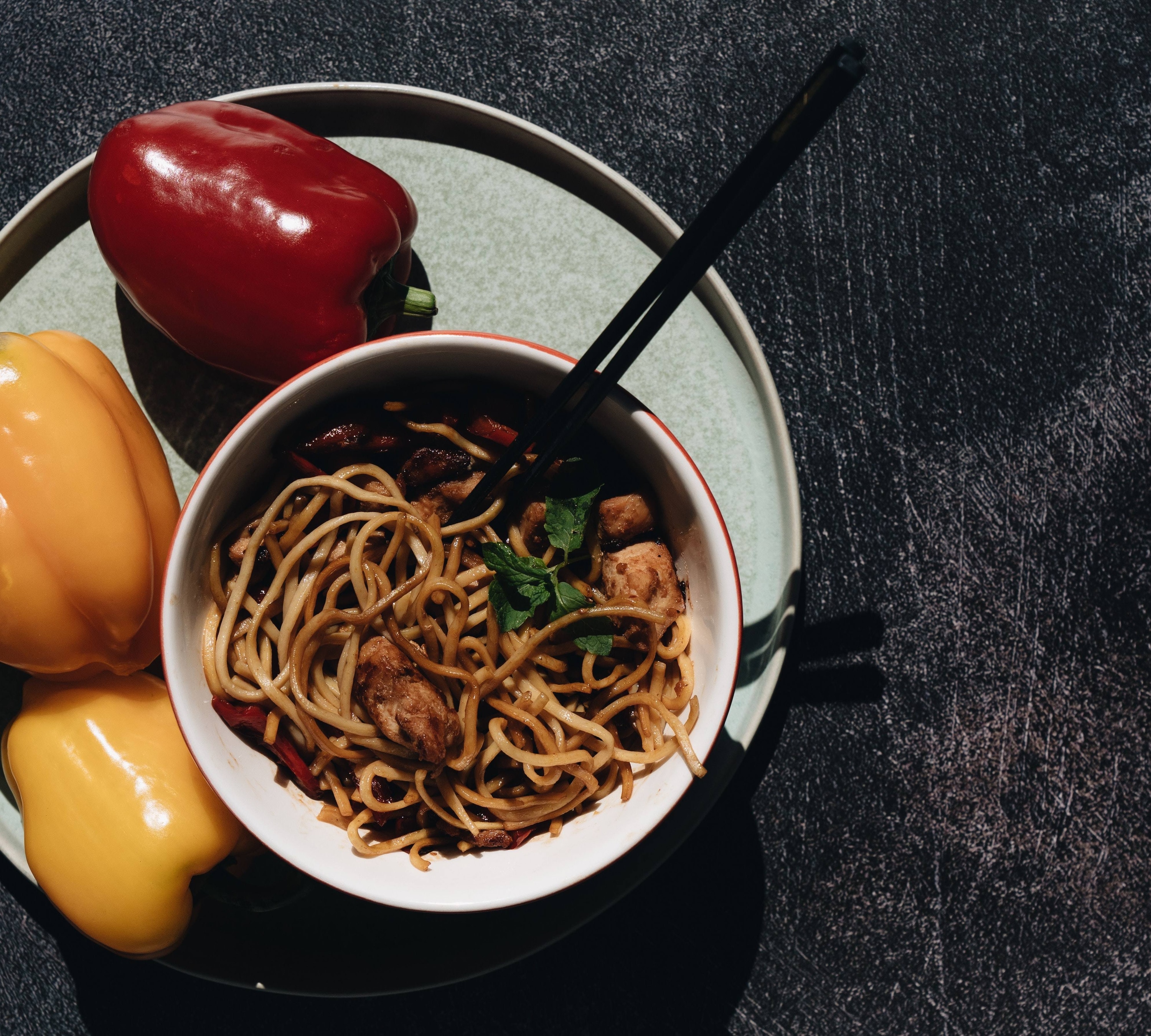 Popular Kung Pao Chicken Pasta with Peanut sauce in a bowl with chopsticks.