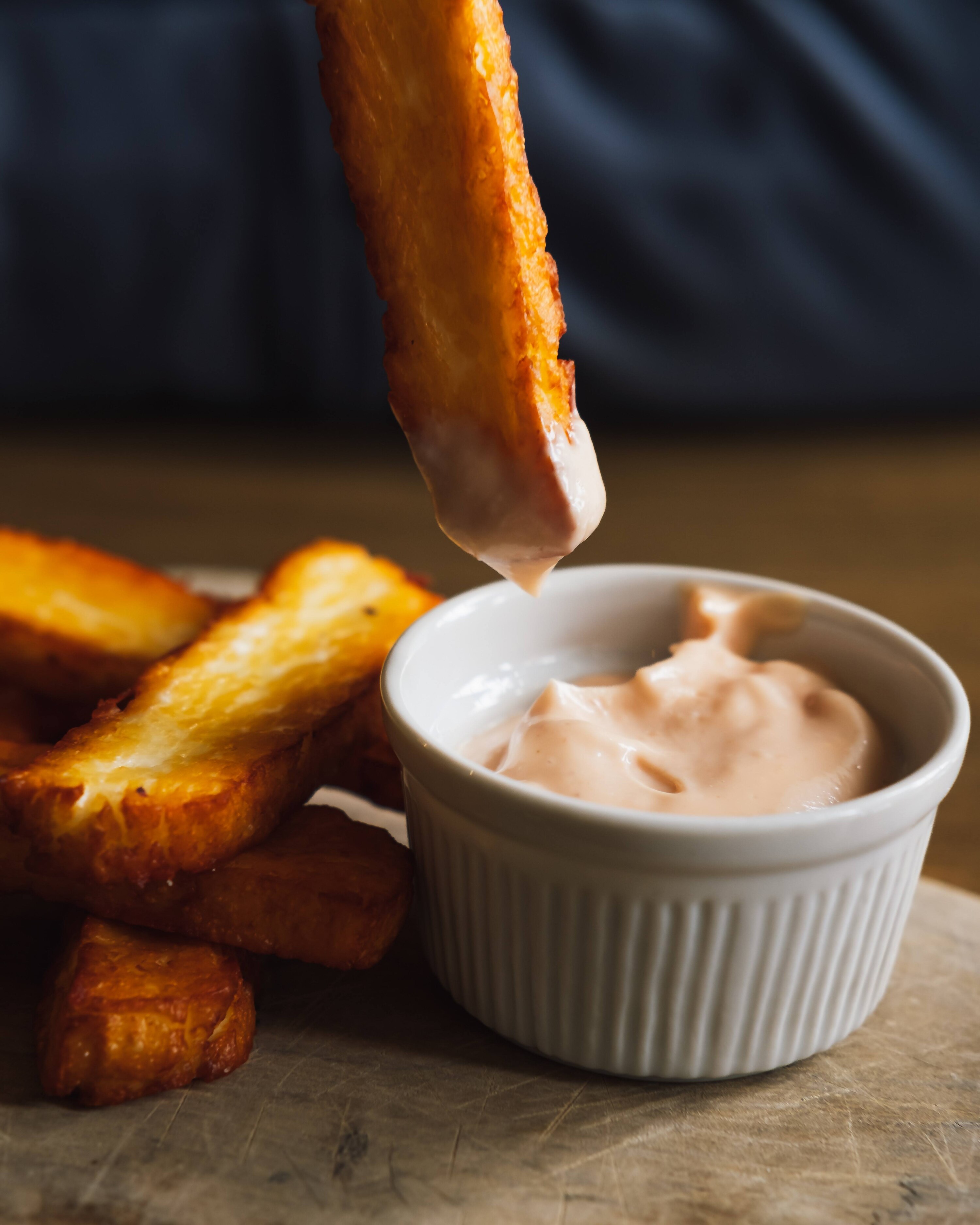 French fry dipped in creamy Cajun sauce