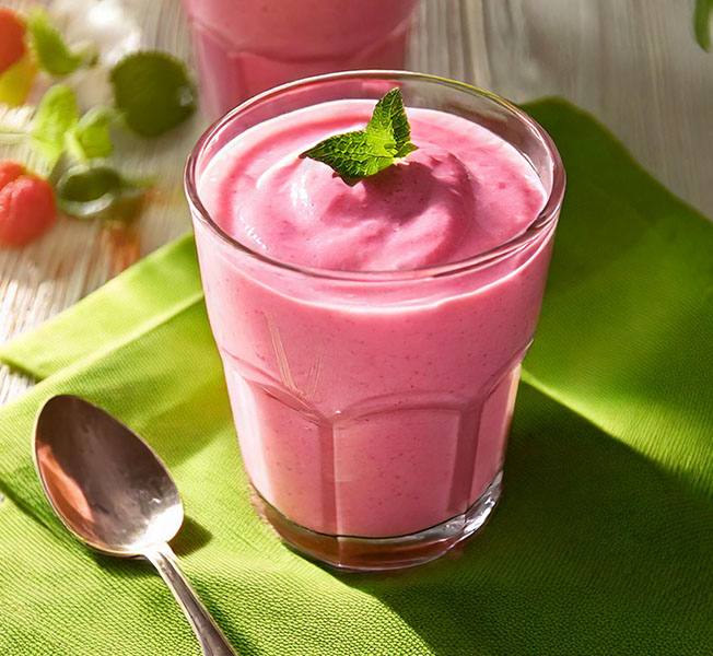 Glass of pink fruit and yogurt ice cream smoothie