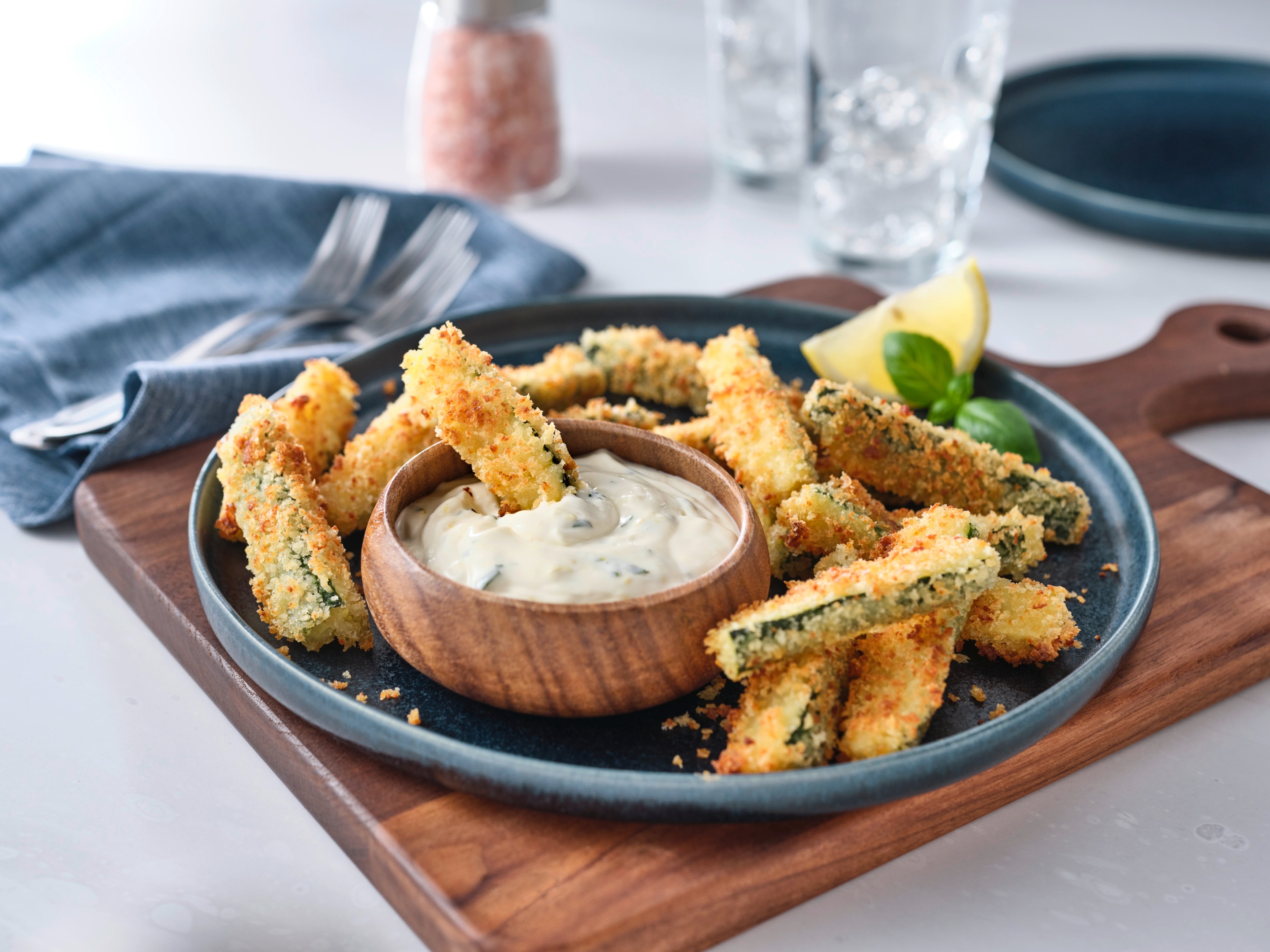 Zucchini fries served on a plate with mayonnaise dip