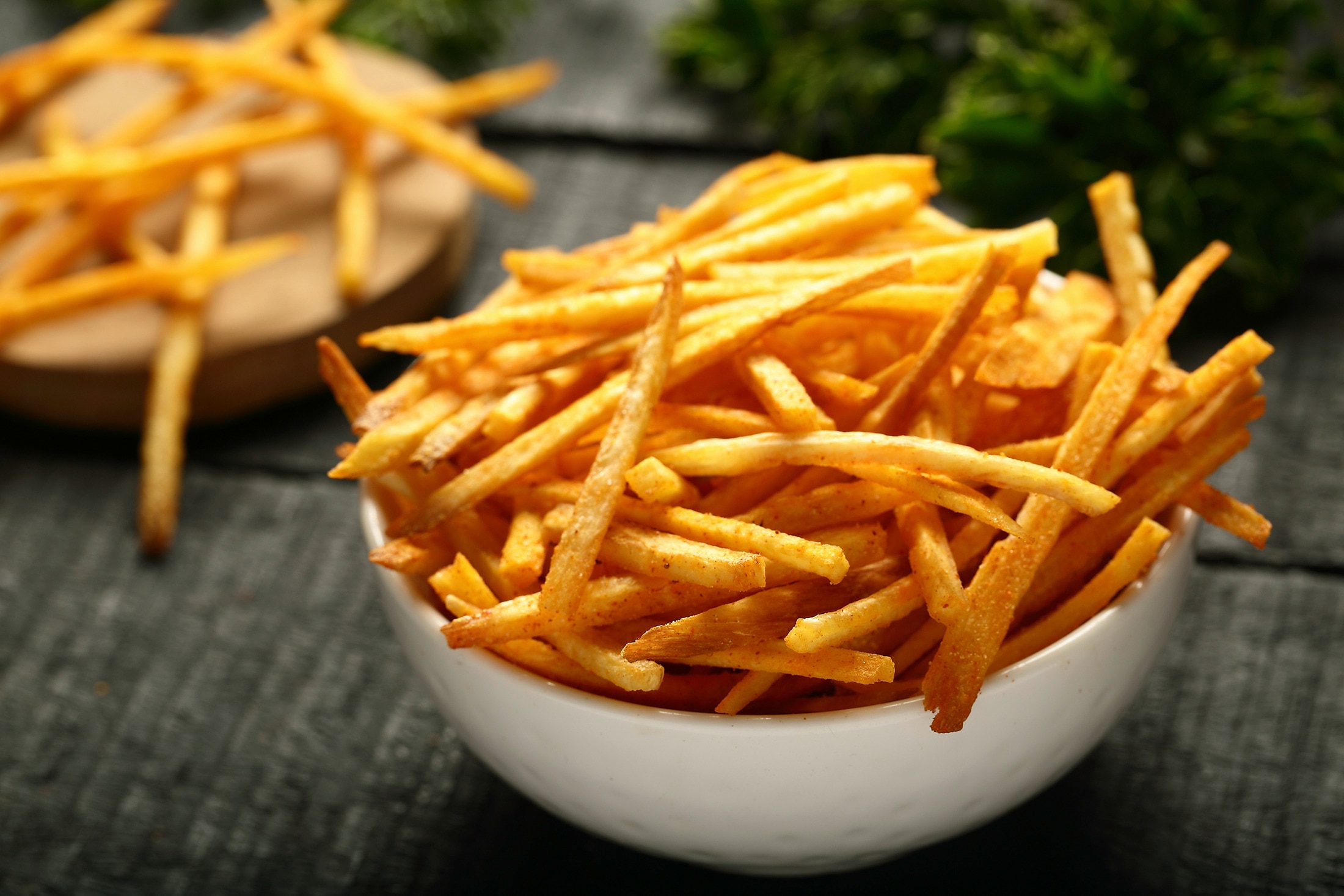 A bowl of freshly cooked and seasoned fries