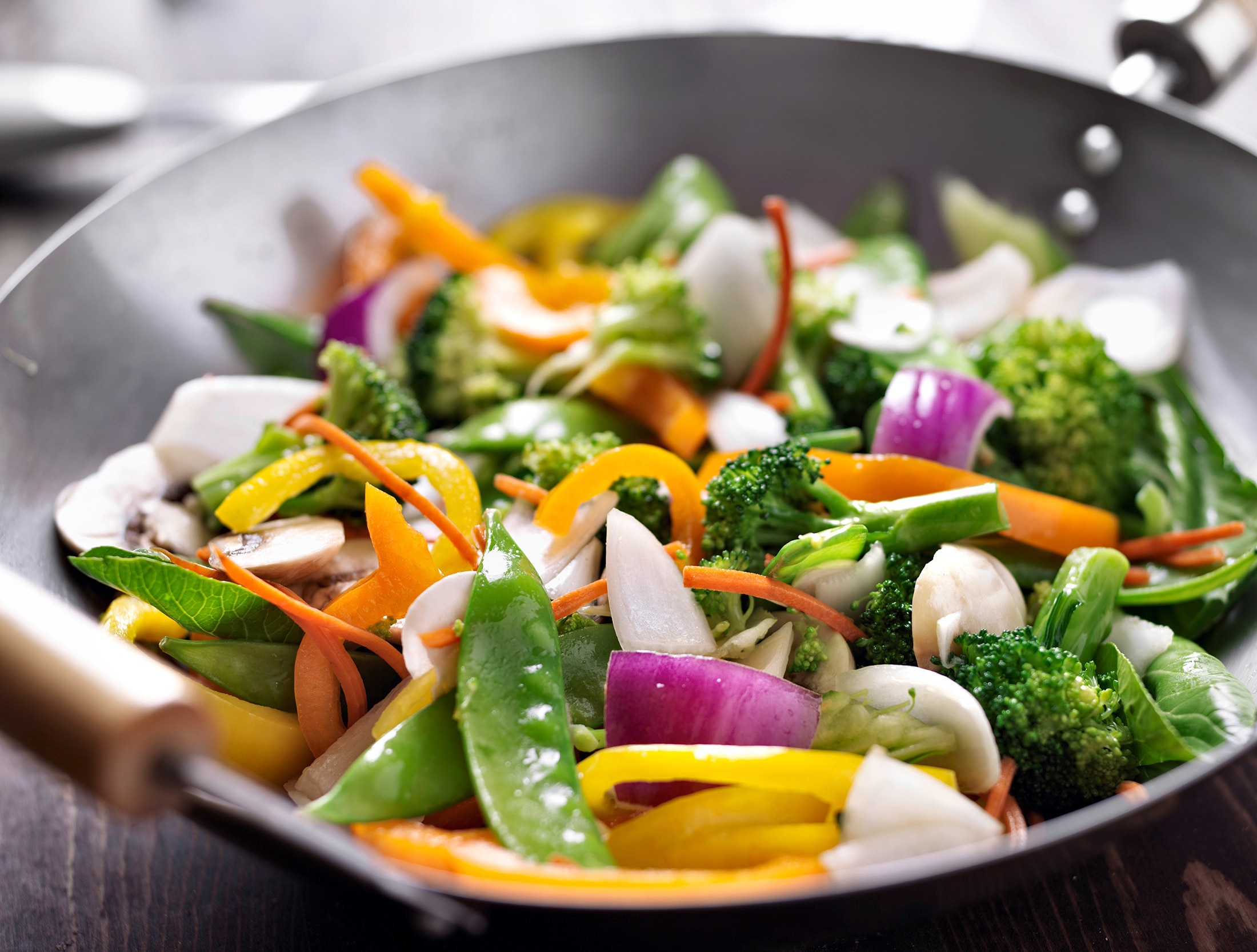 Stir-fried vegetables being cooked in a wok