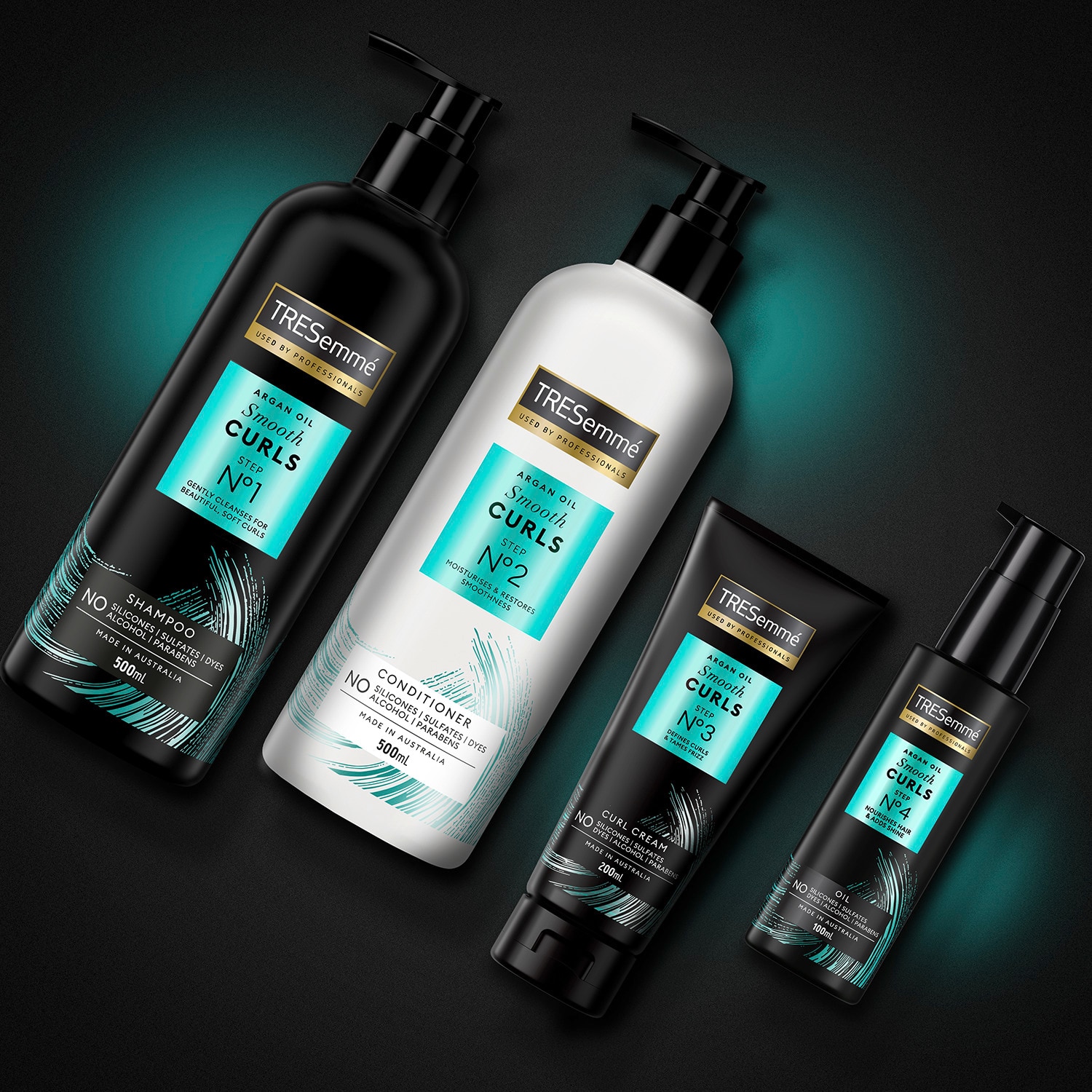 Product shot of TRESemmé Smooth Curls shampoo, conditioner, cream and oil