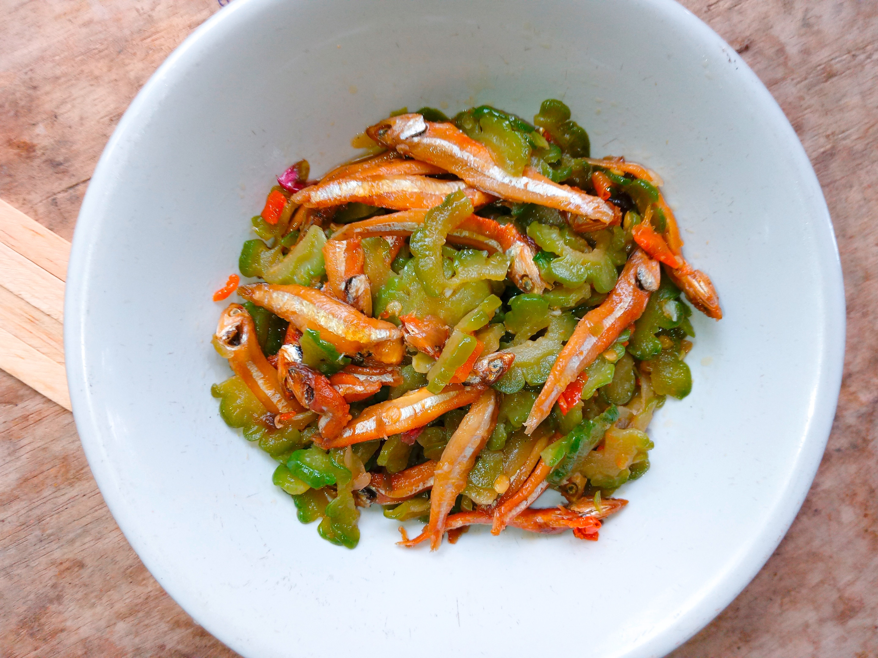 A bowl of ginisang ampalaya topped with fried dilis