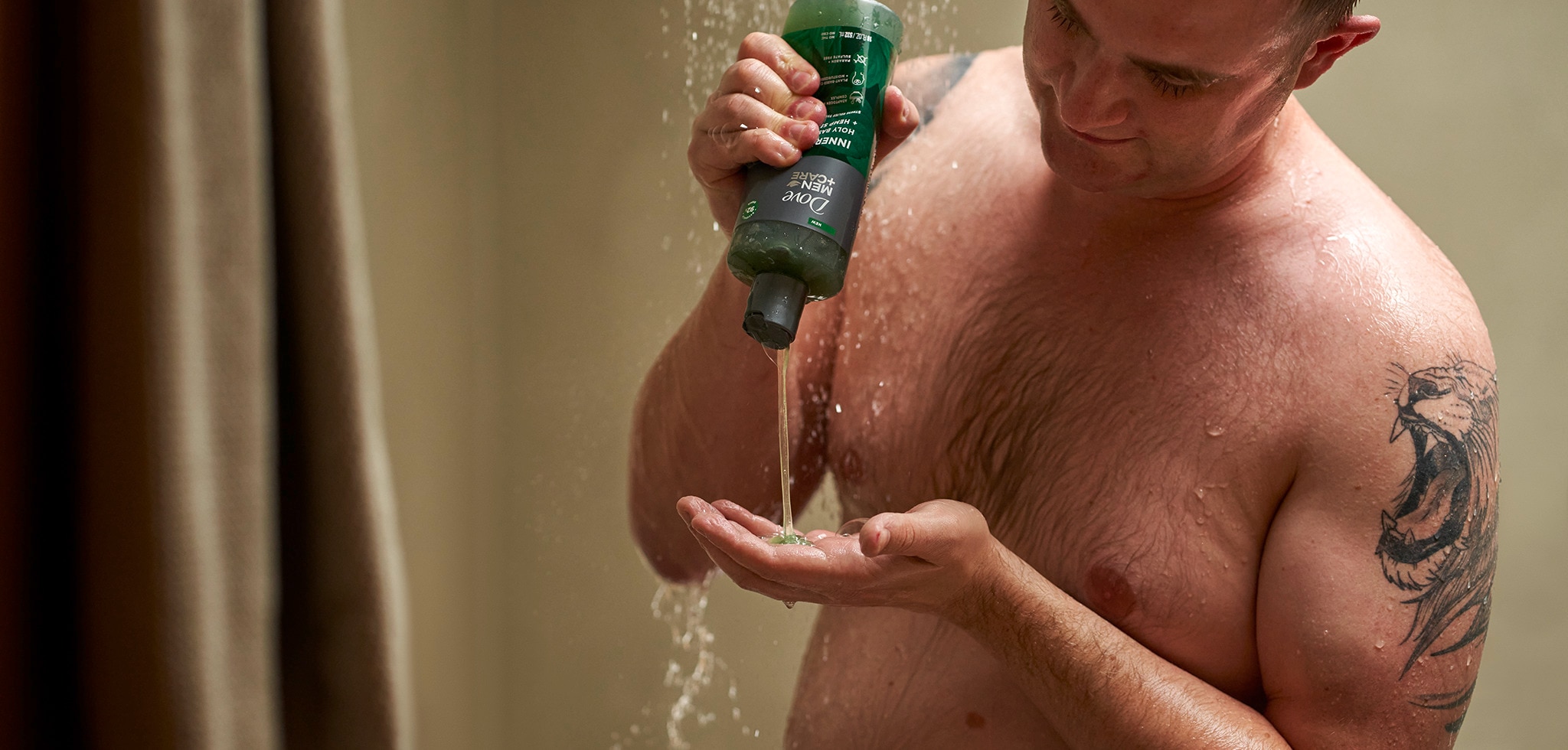 Man squeezing soap bottle