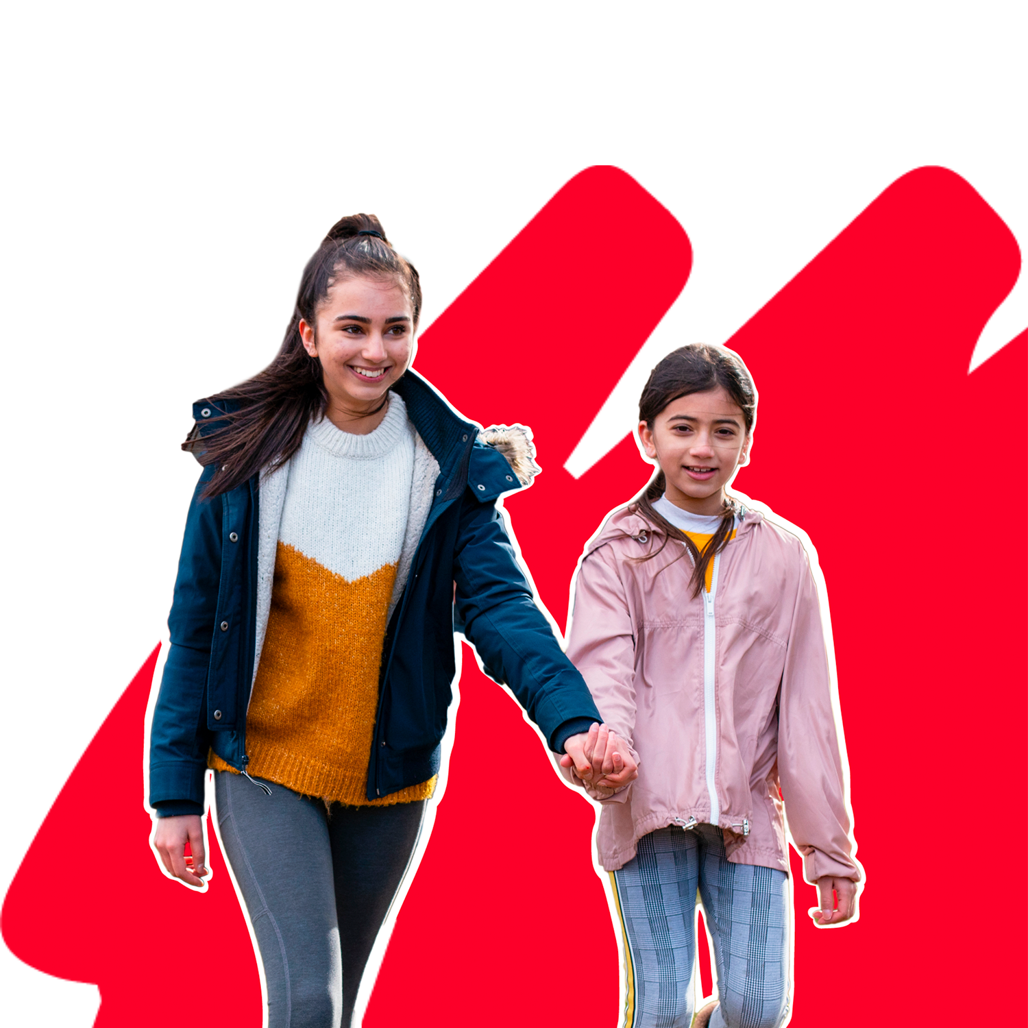 An older girl and younger girl holding hands while walking and smiling