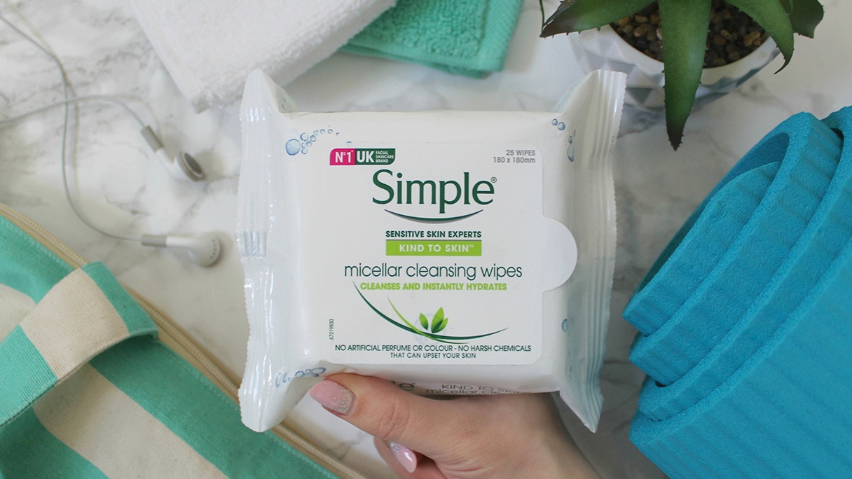 A pack of Simple Micellar Cleansing Wipes with gym accessories in the background