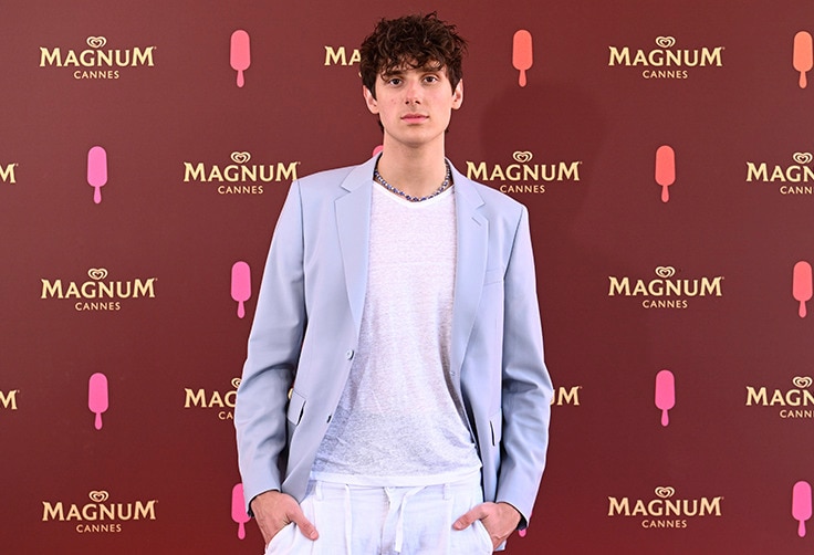 JVKE standing in front of Magnum branded wall