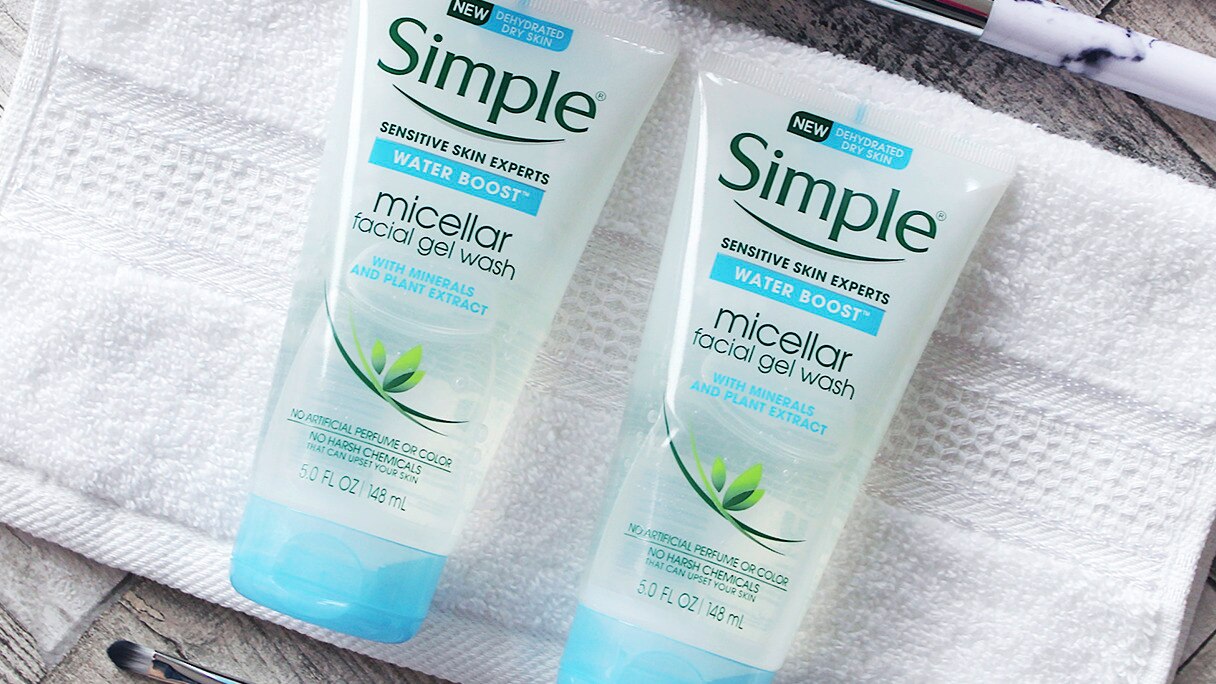 Two tubes of Simple Water Boost Micellar Facial Wash Gel on a face cloth