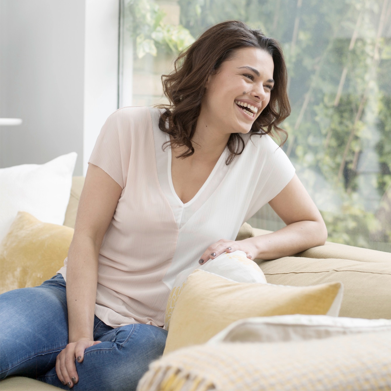 A beautiful woman with moisturised skin laughing