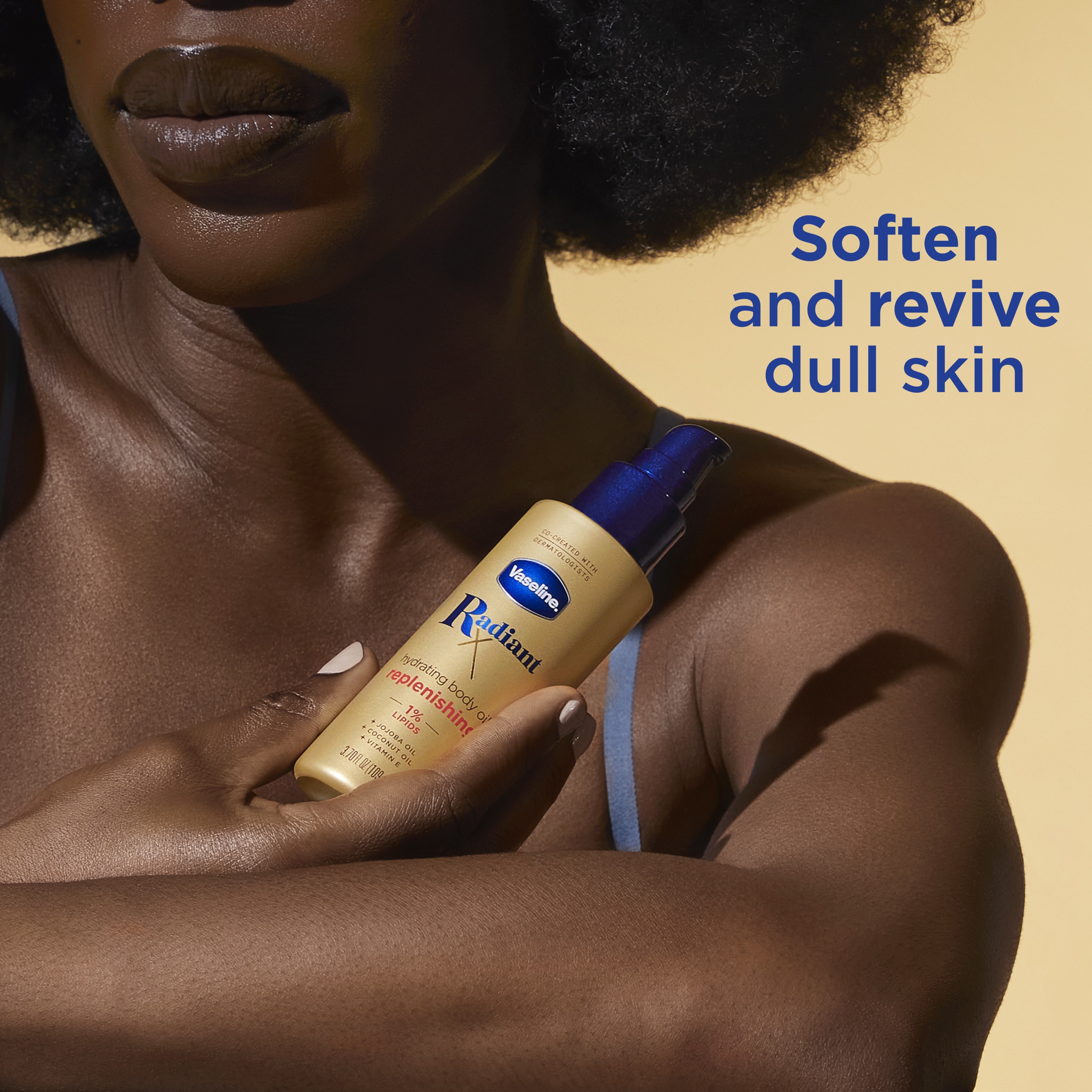 Woman holding Vaseline® Radiant X Replenishing Body Oil