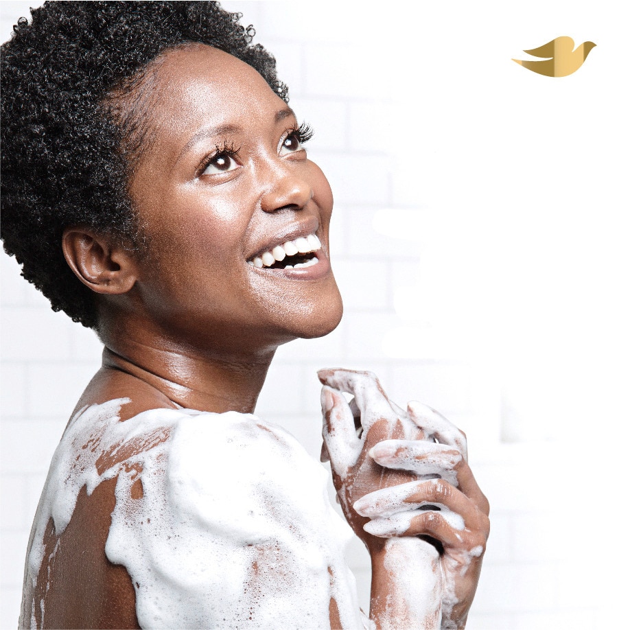 Woman with foam taking a shower