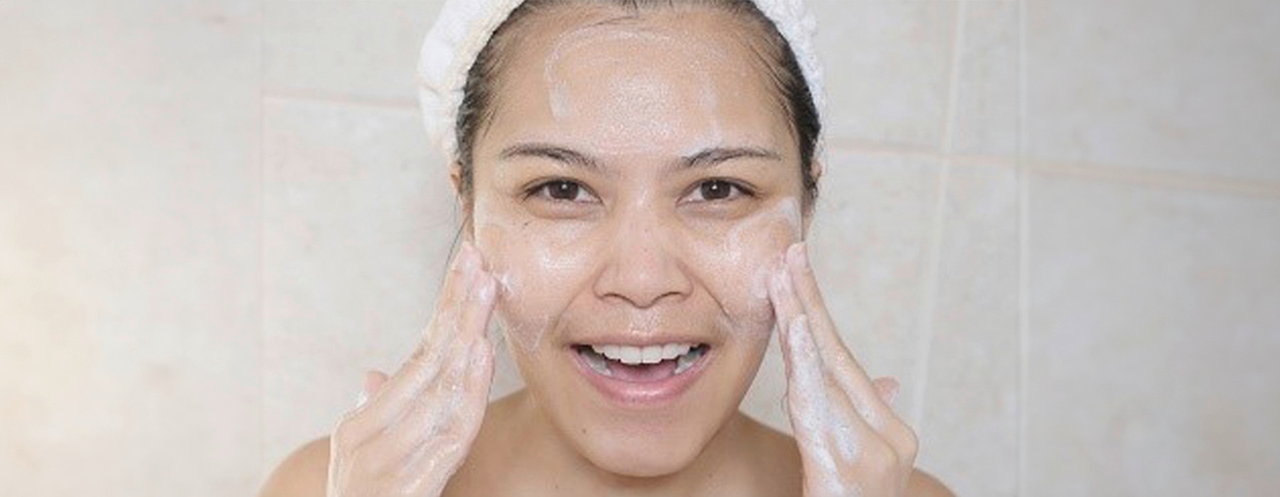A beautiful woman doing her facial to target uneven skin tone on her face