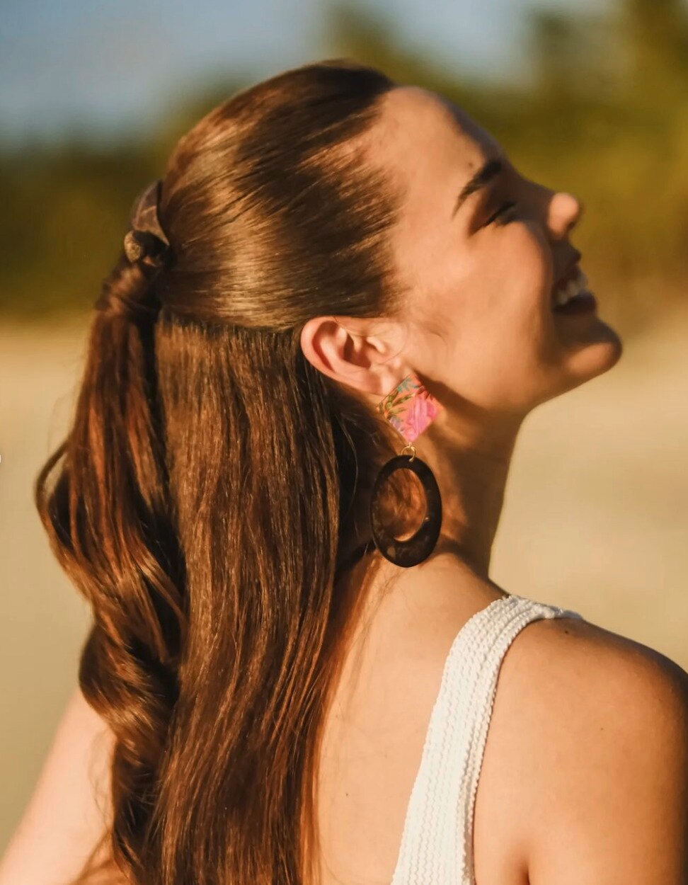 Profile of Catriona Gray wearing a half ponytail.