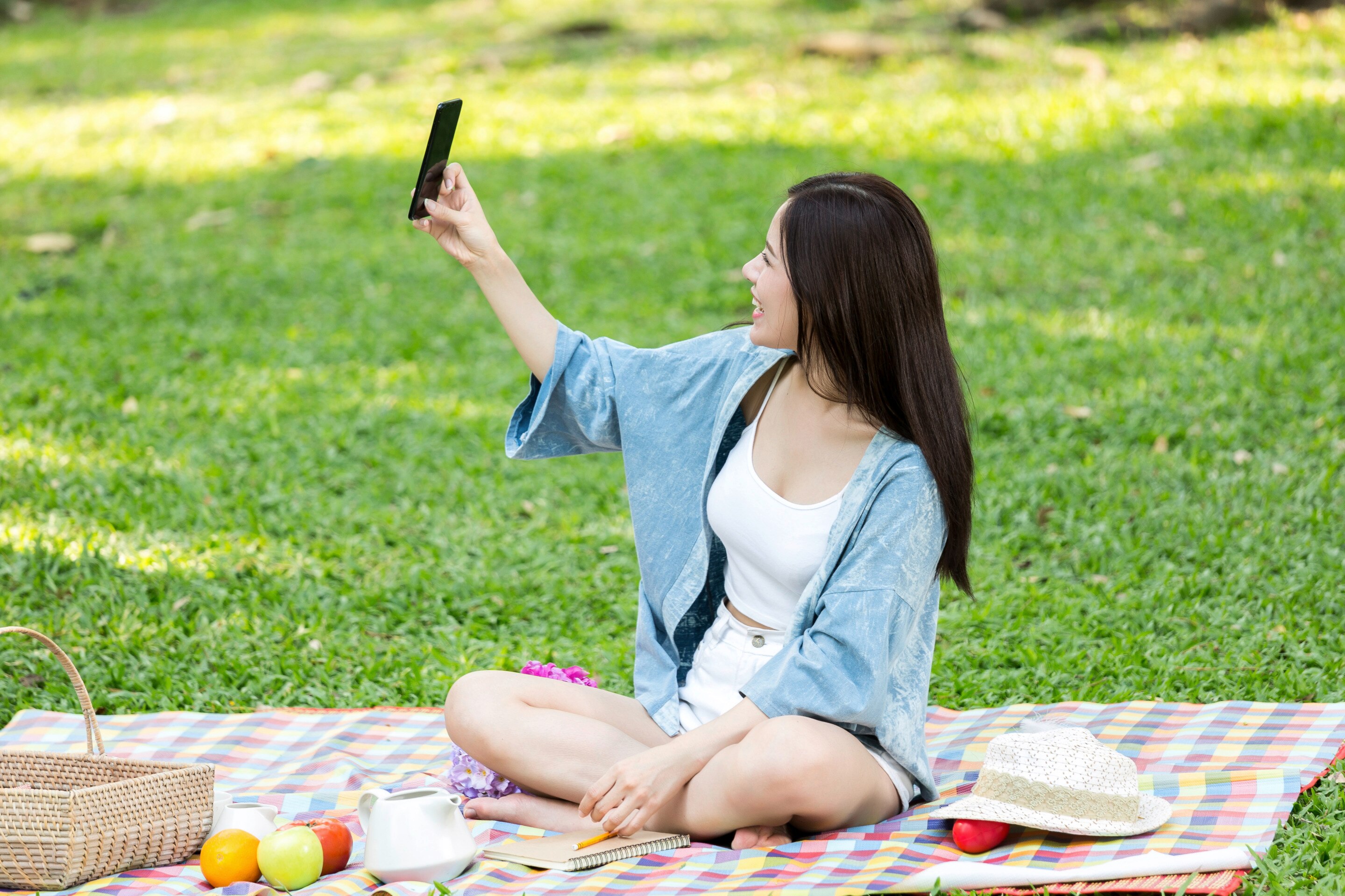 A woman outdoors having a picnic