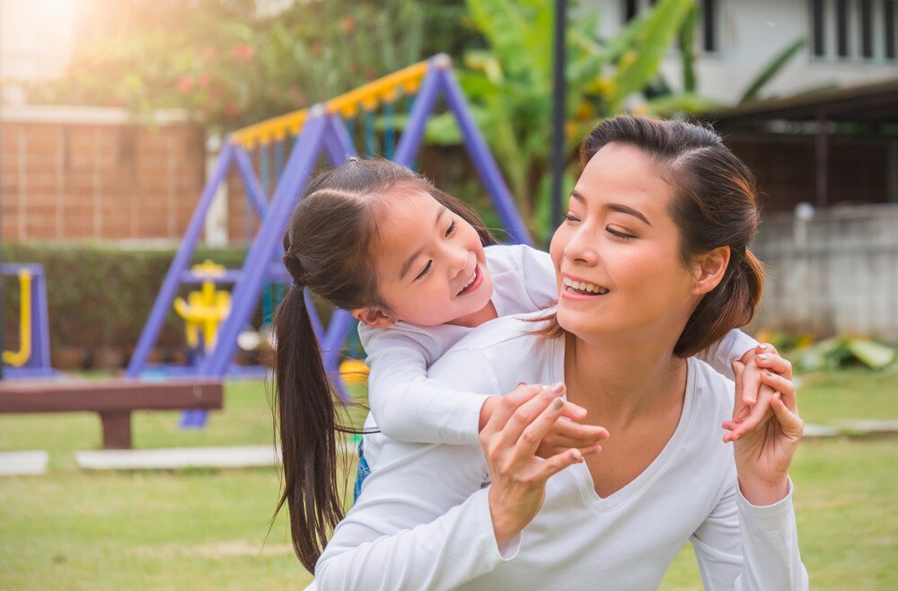 Mother and daughter at a playground.
