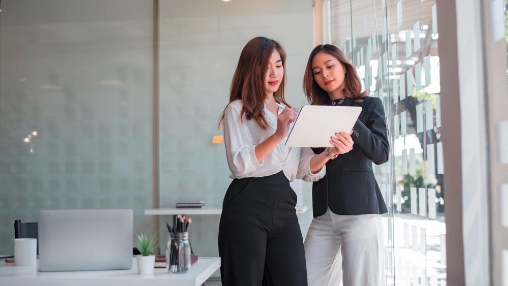 Young woman being mentored by an older colleague.