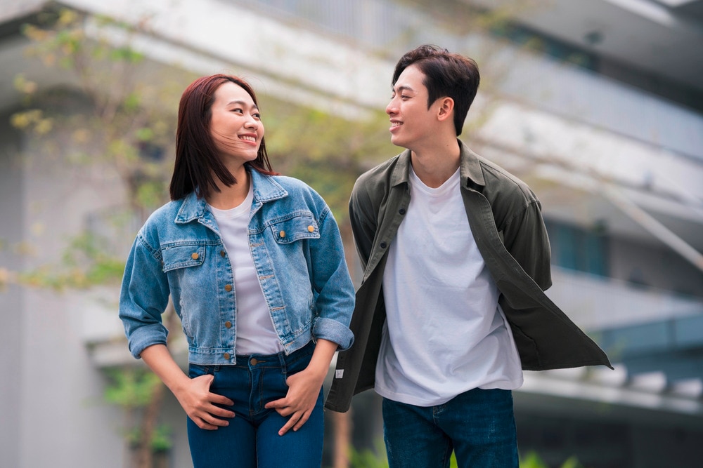 Woman walking beside her partner while looking at each other.