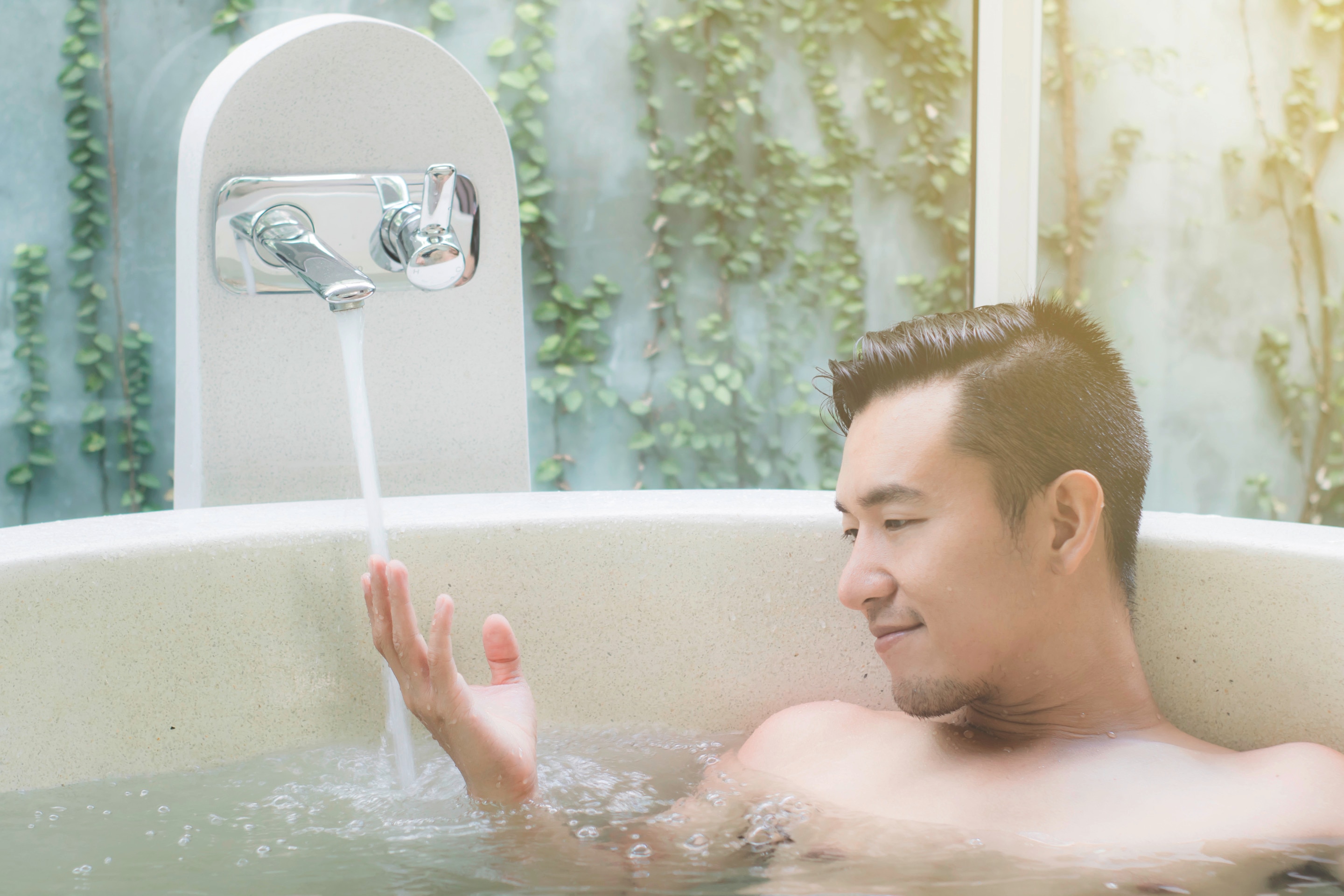 A man in a bathtub relaxing
