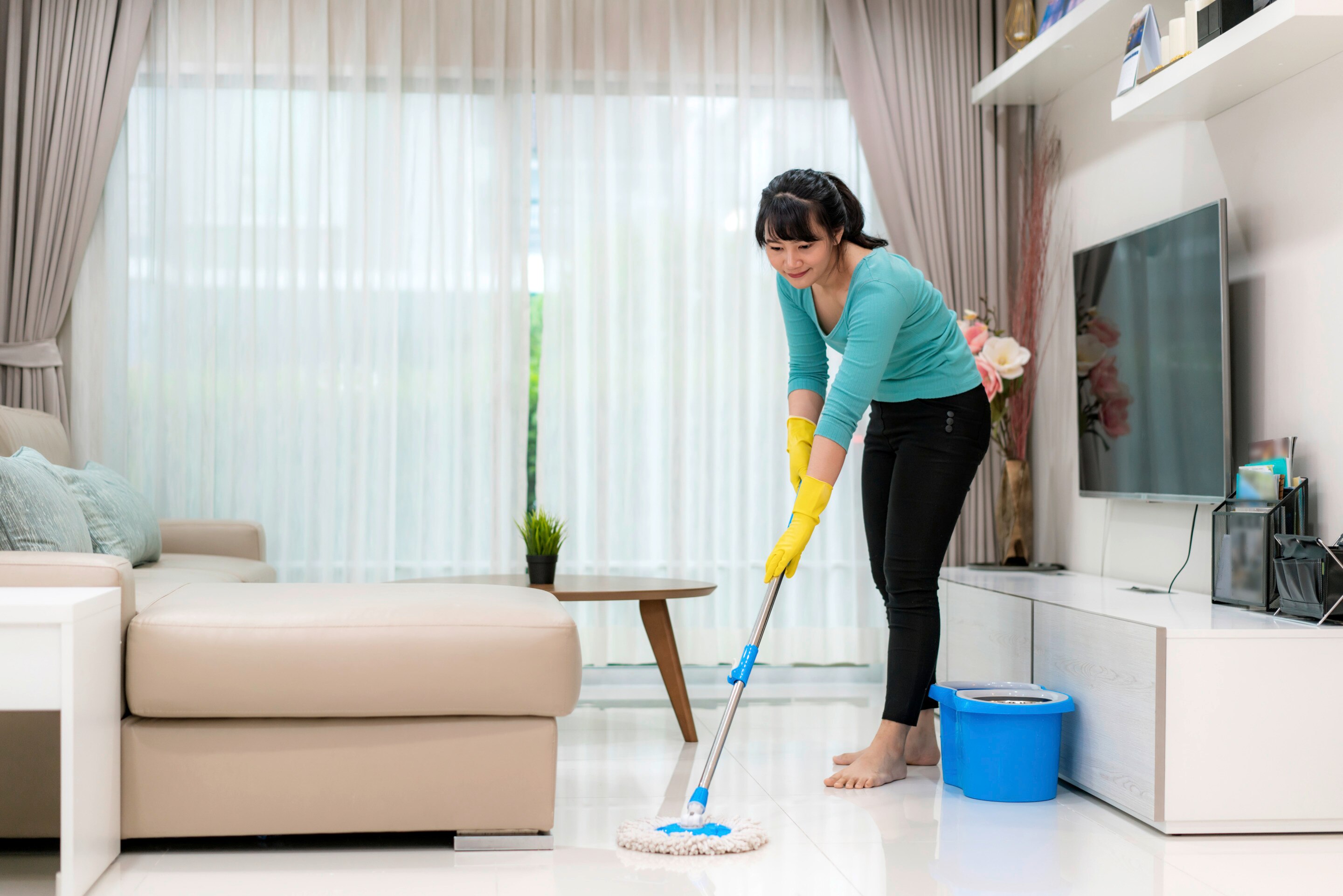 A woman mopping the floor