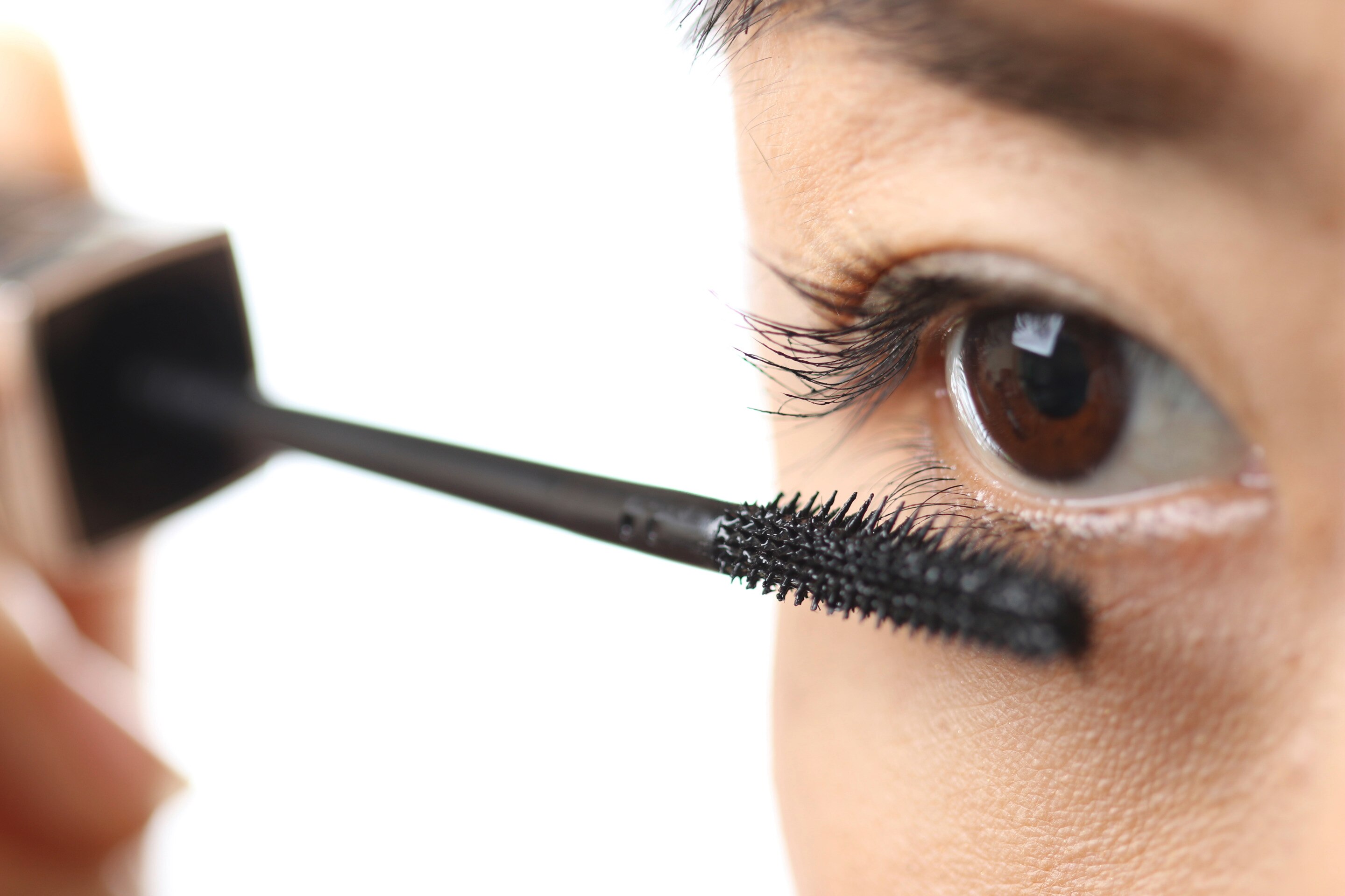 Woman applying mascara