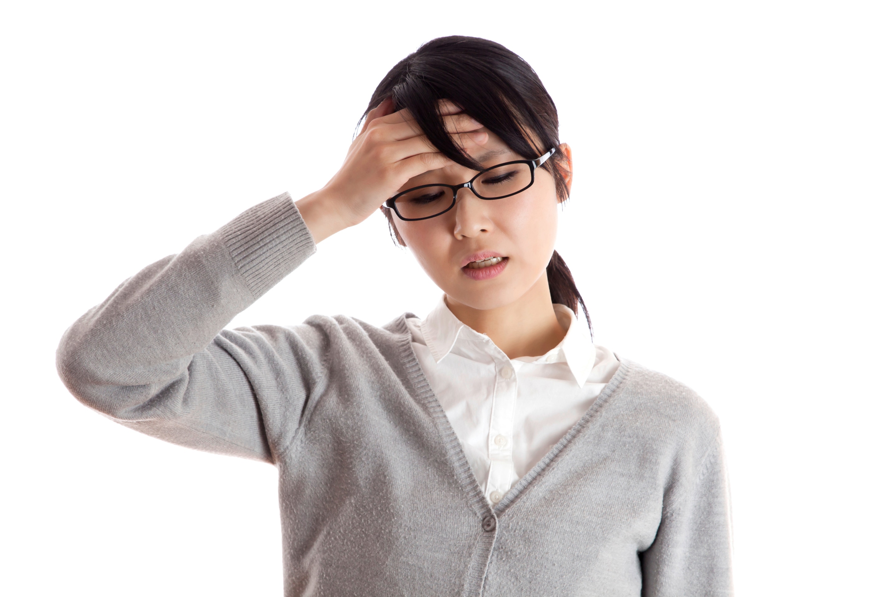 Asian woman in gray cardigan touching forehead with headache