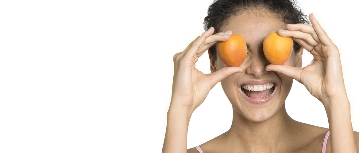 model with two apricots over eyes