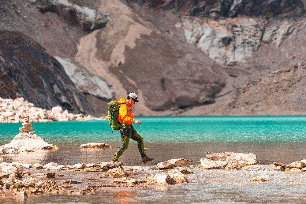 Asian hiker at a river crossing.