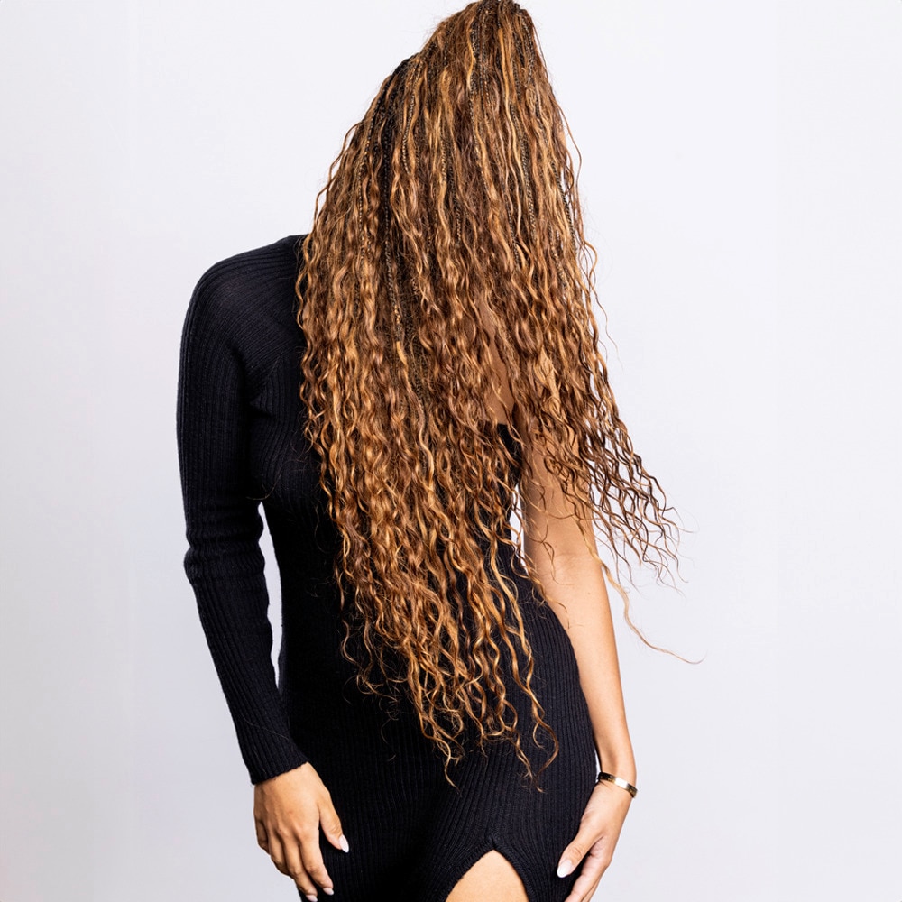 Woman shaking her long curly hair