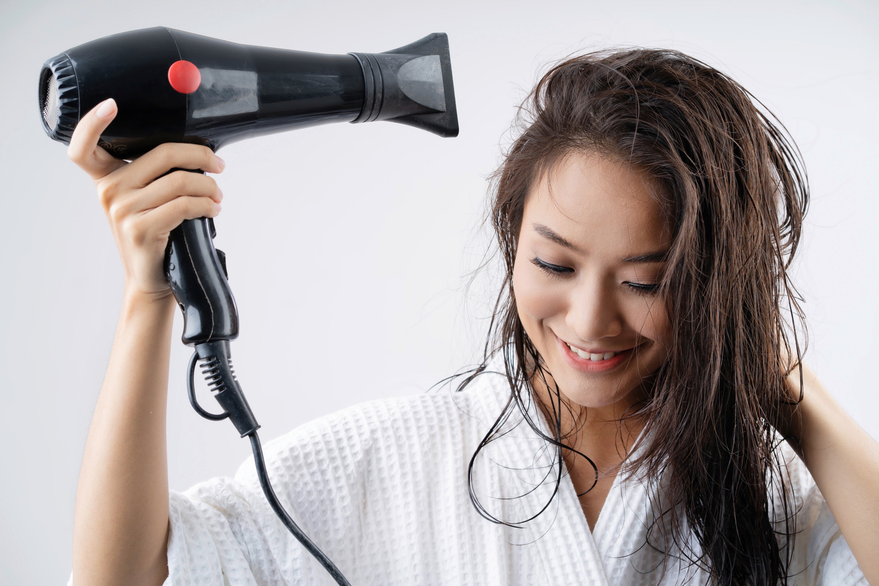 Asian woman drying her hair