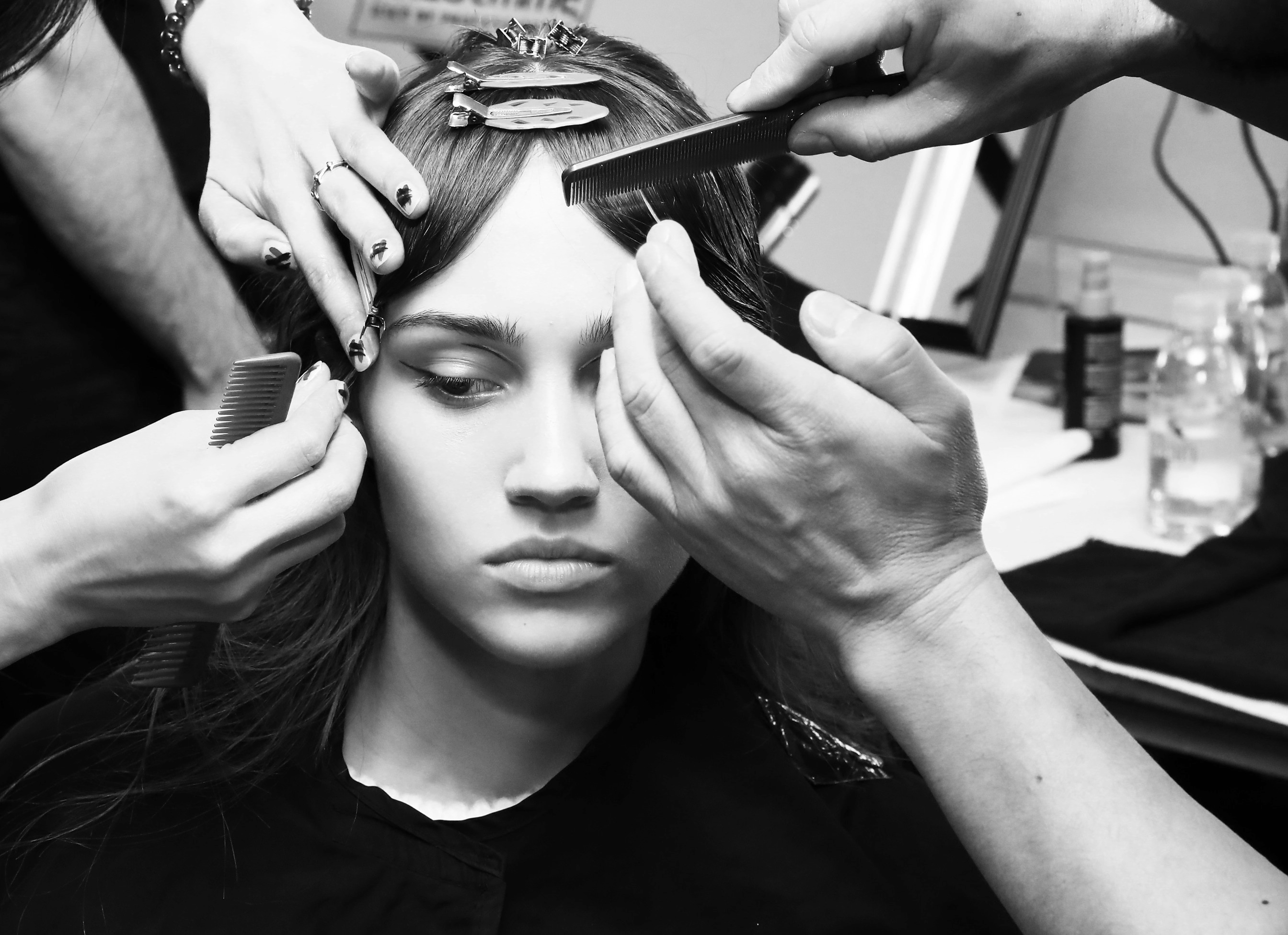 Stylists creating a center part
