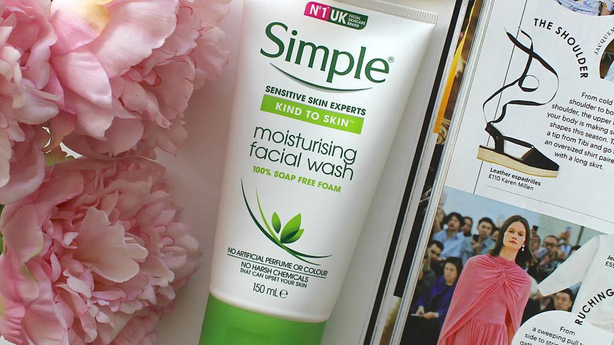 Tube of Simple Moisturising Facial Wash alongside flowers