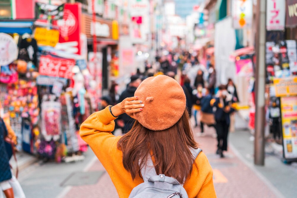 Back of a female Asian tourist in Harajuku lane.