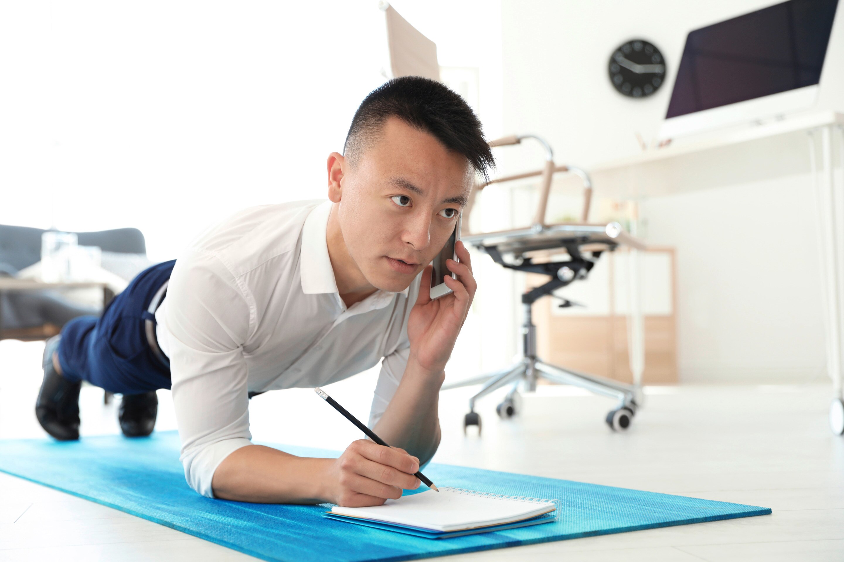 Asian man doing exercises at the office 