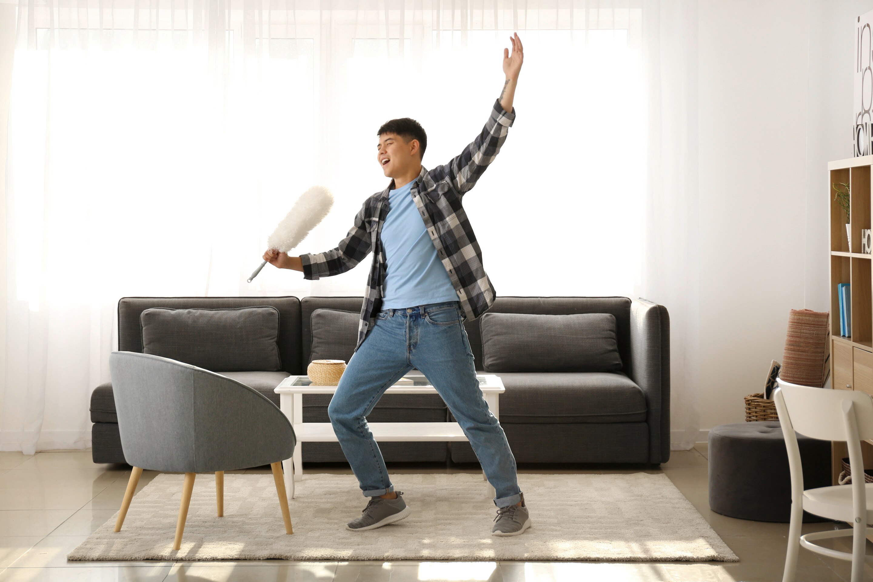 Asian man singing while cleaning.