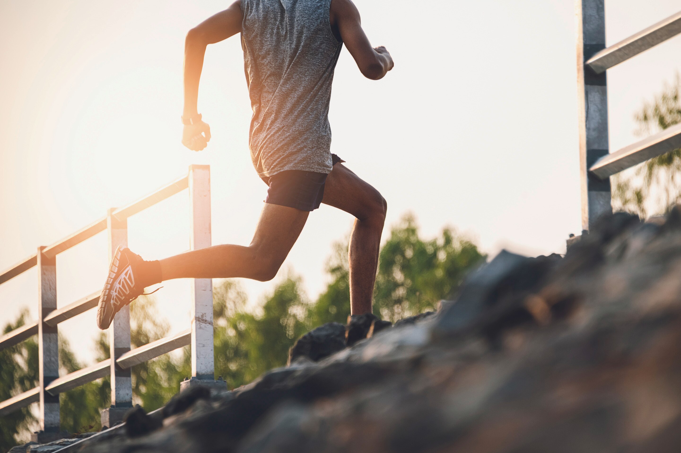 Asian man running up steps 