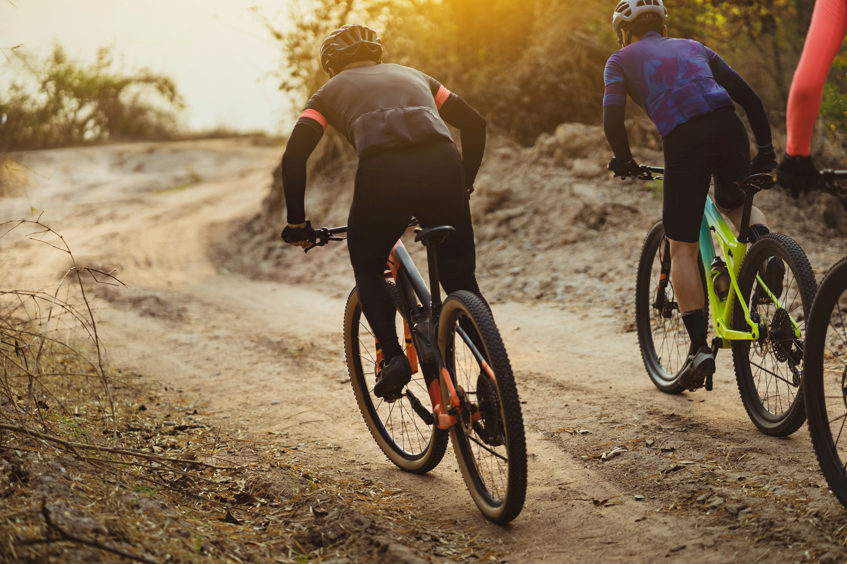 Men cycling on a dusty bike trail