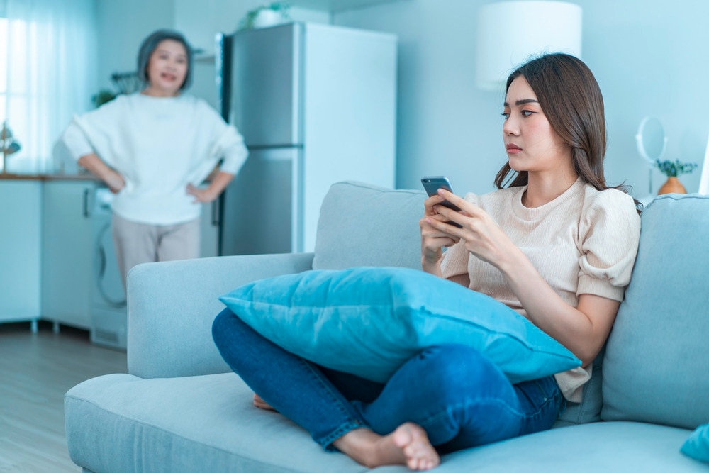 Senior Asian mom angry at upset daughter.