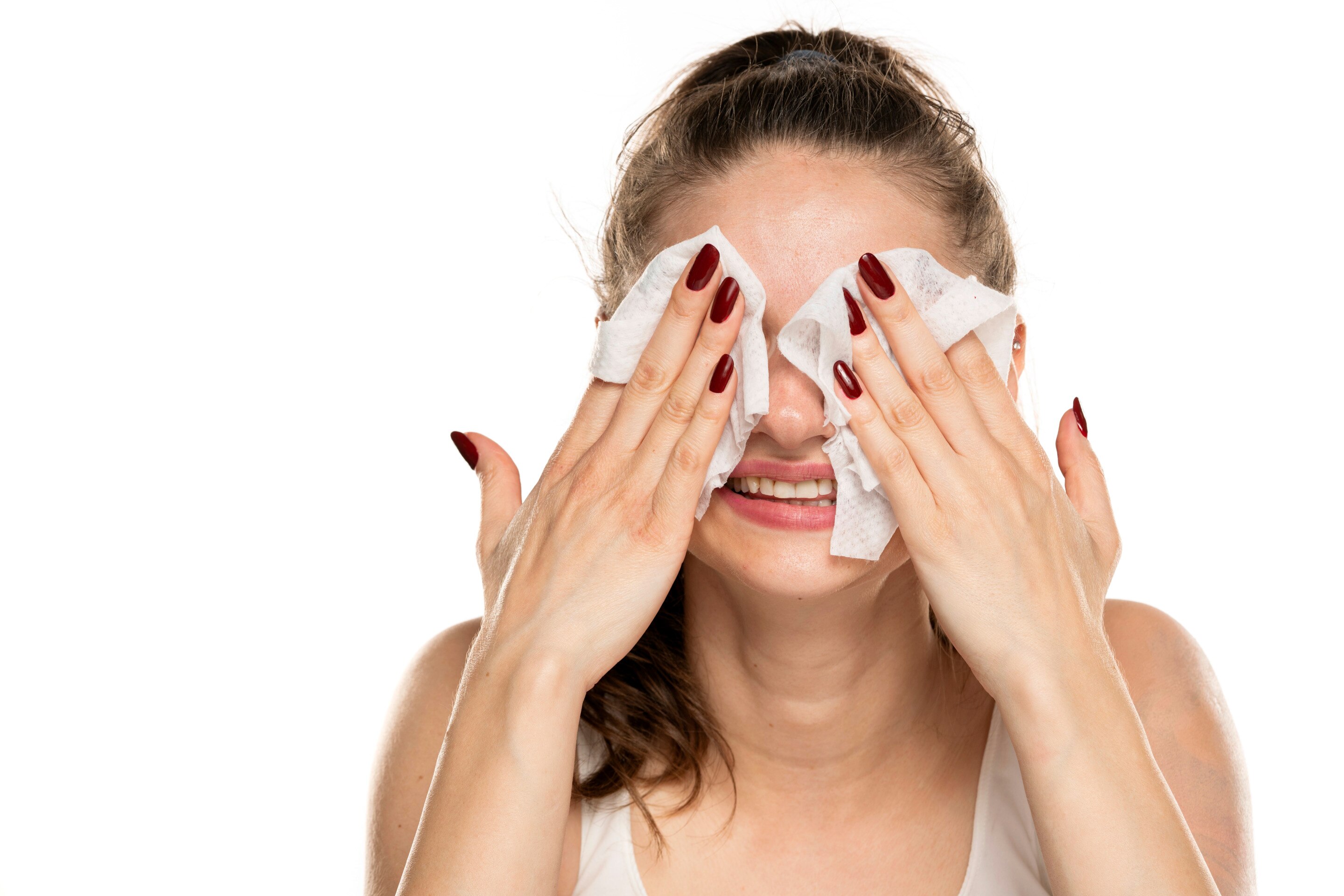 Woman removes makeup with cleansing wipes