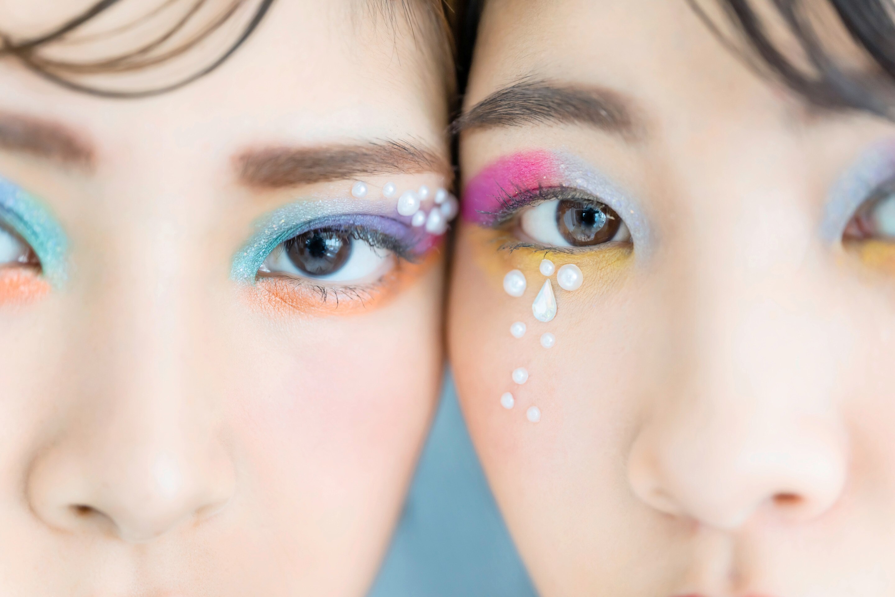 Asian girls with colorful, glitter makeup