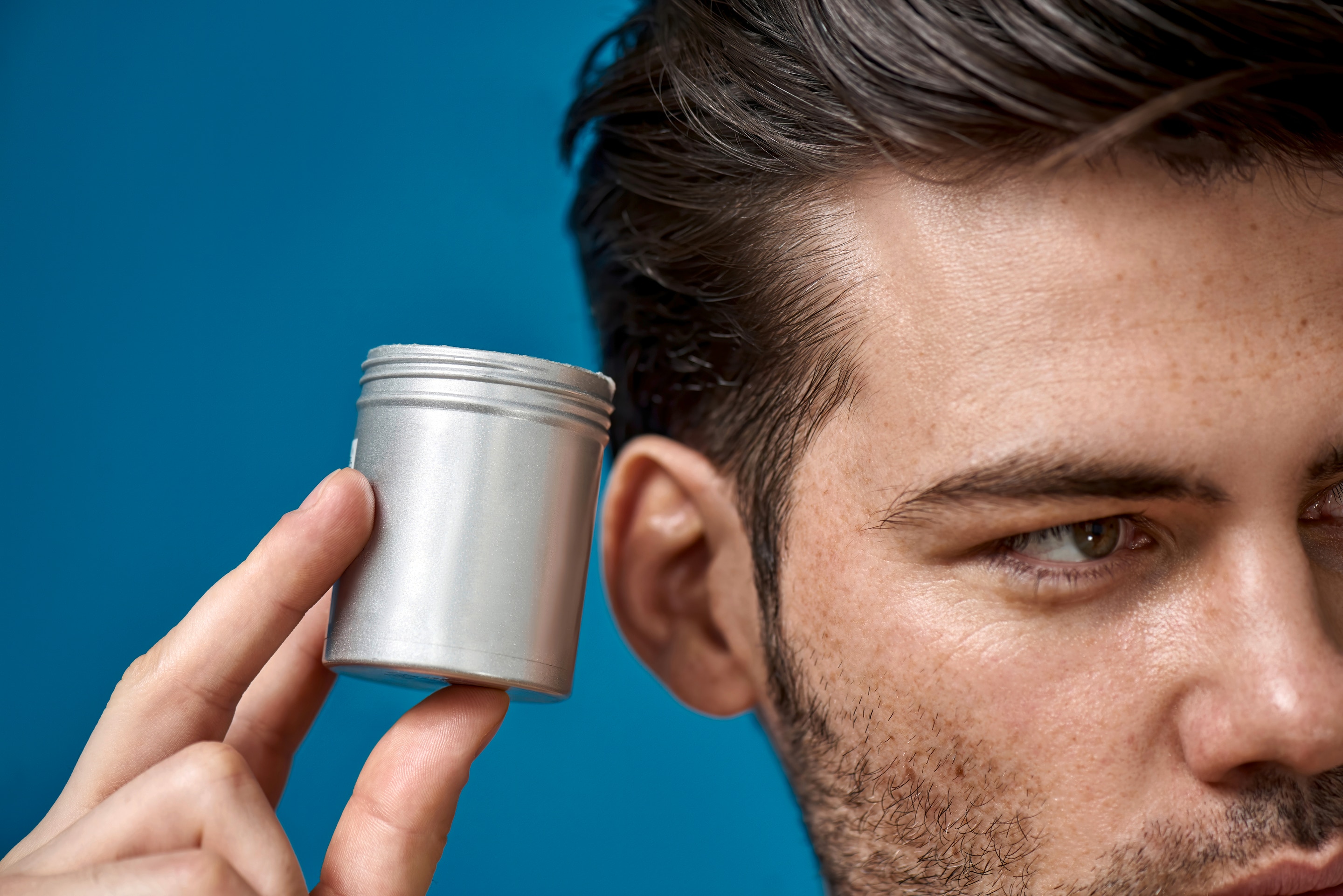 Man with tin of hair wax