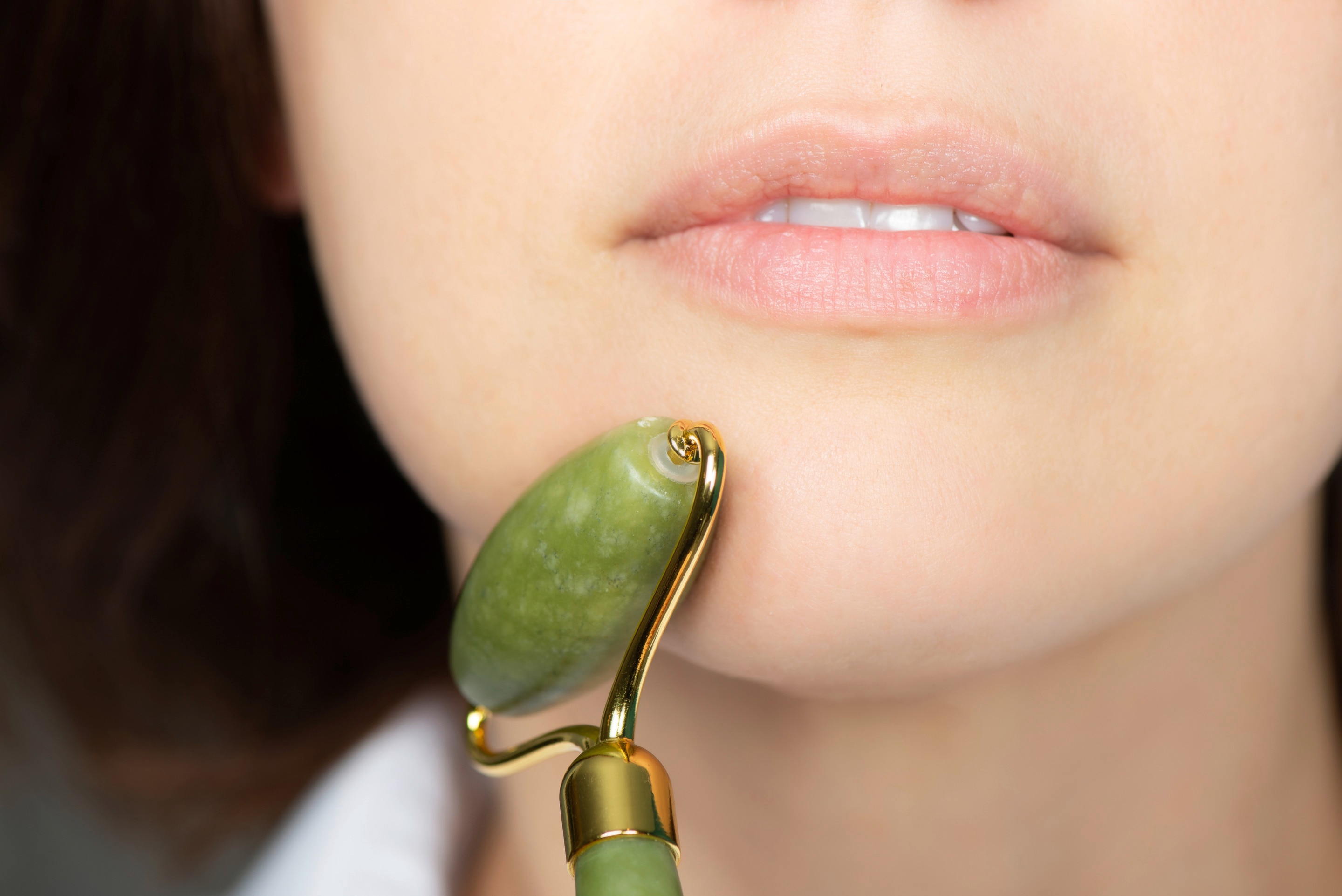Woman using a jade roller