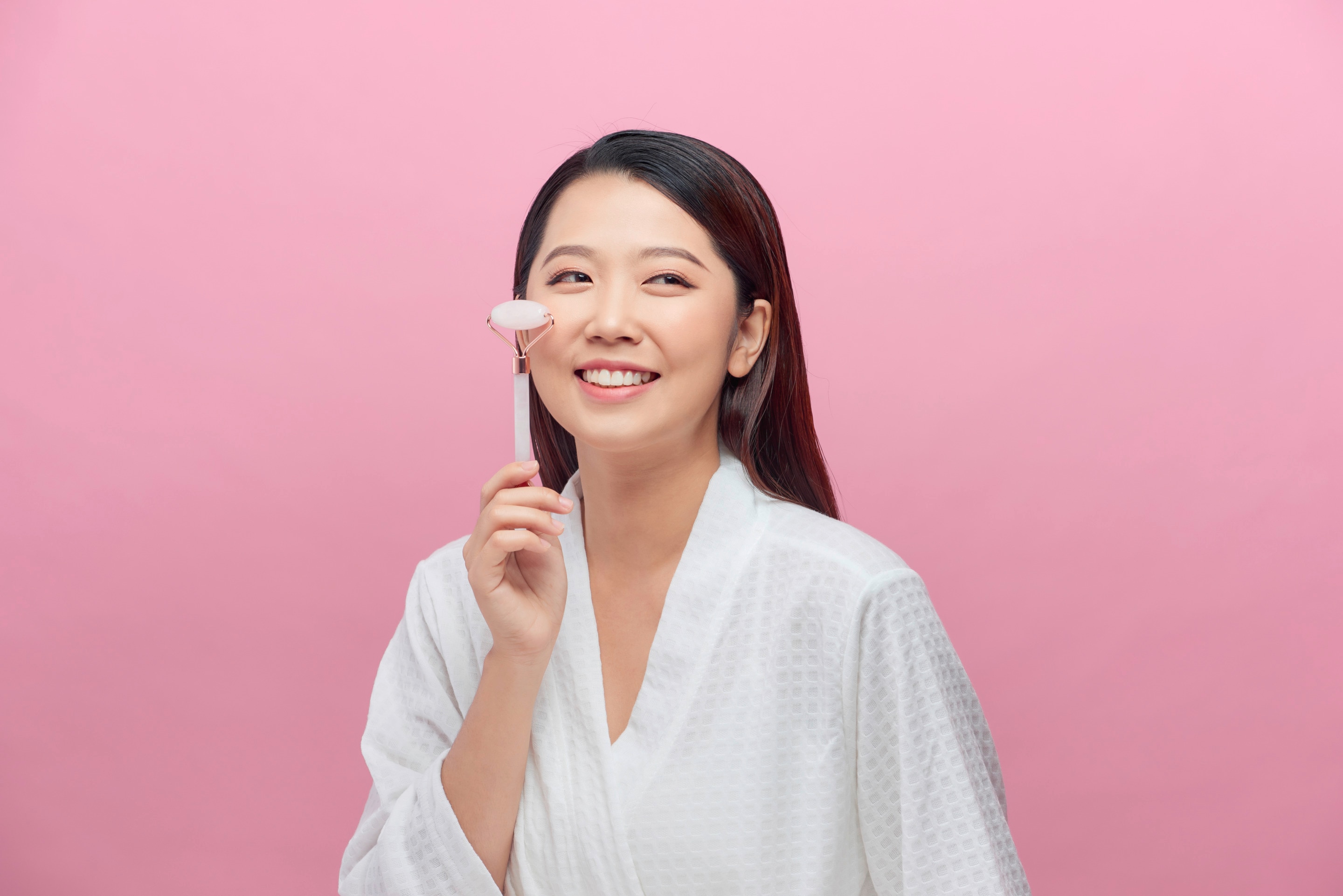 Asian woman using a quartz roller