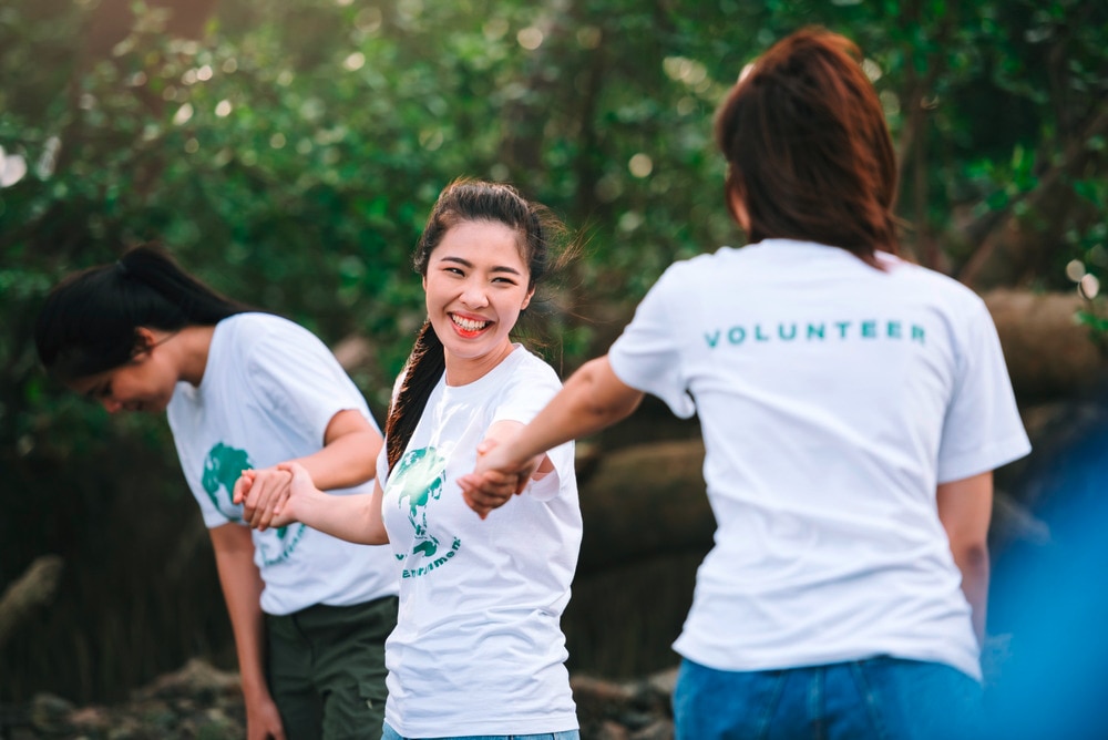 A portrait of female volunteers working together outdoors.