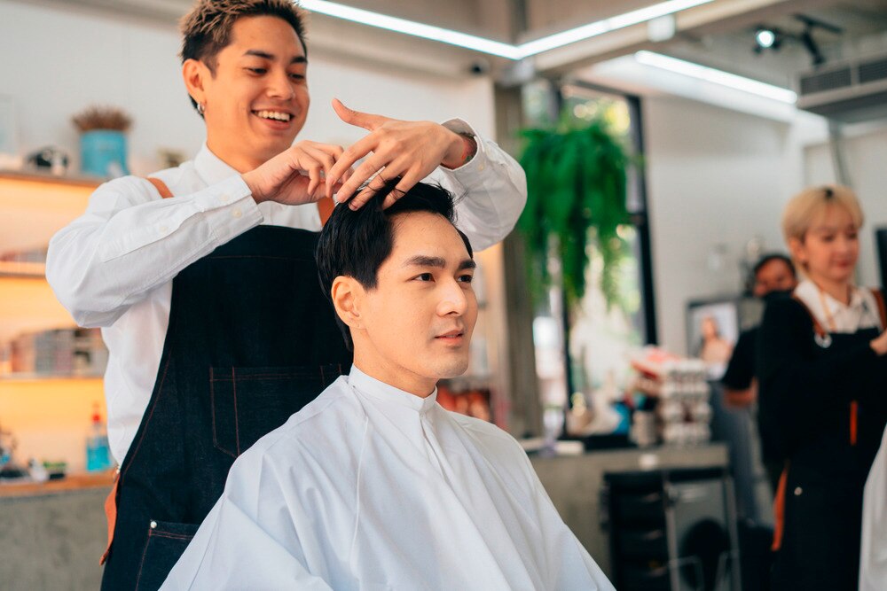 Man having his hair cut by a barber.