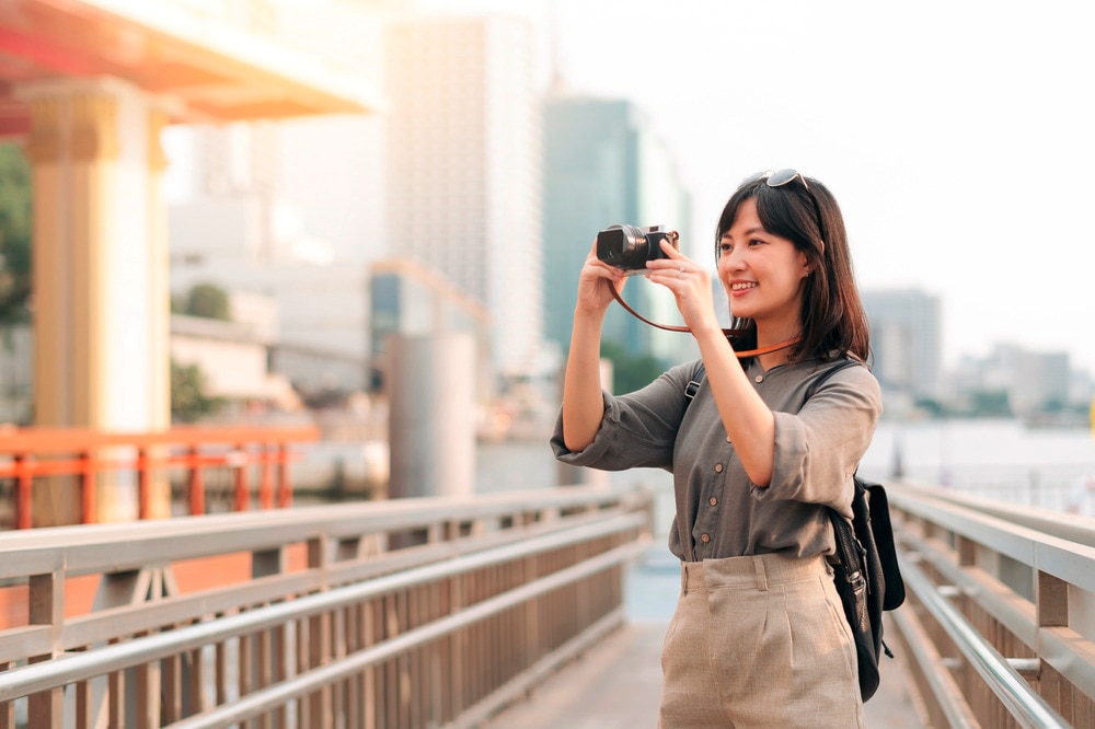 Female traveler taking pictures in Bangkok.