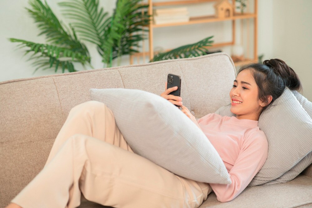 Asian woman relaxing on the couch.