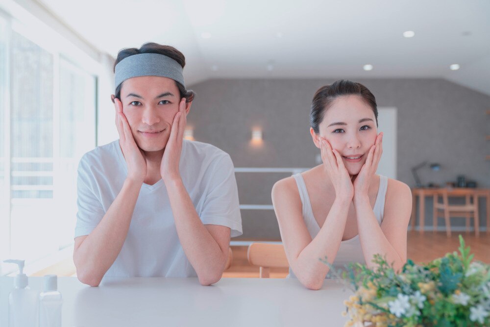 Woman and man doing skincare routine together.