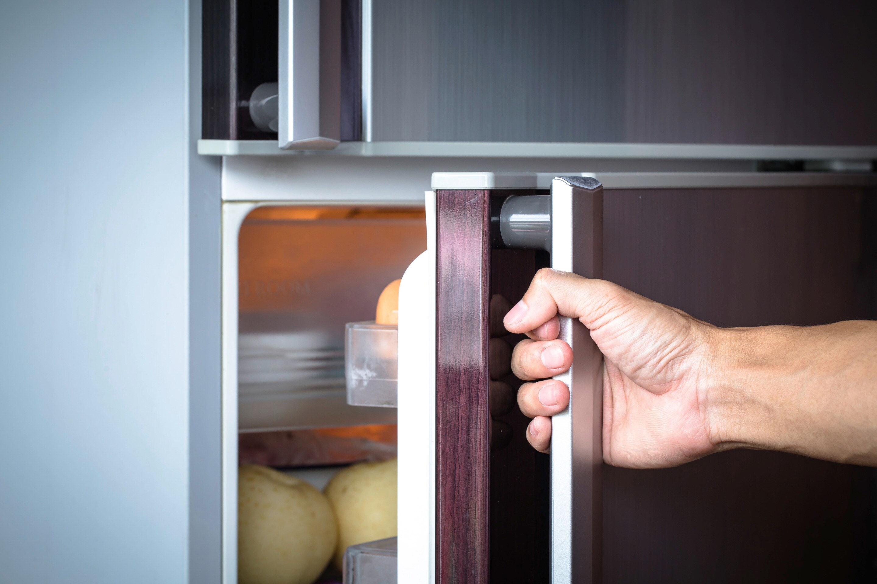 Man opening refrigerator